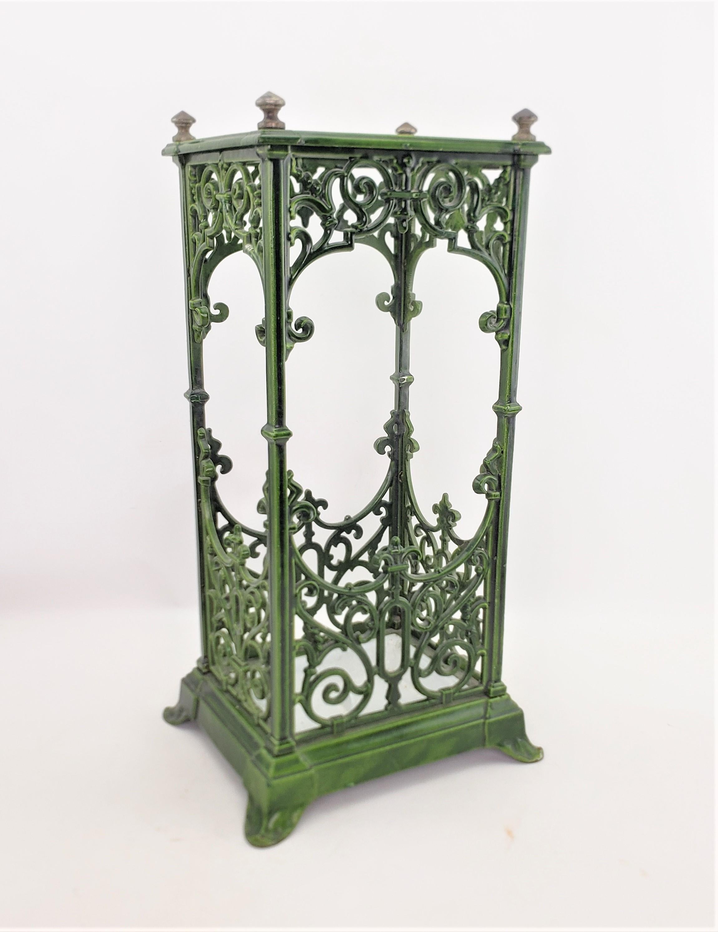 This antique walking stick or umbrella stand is unsigned, but presumed to have originated from England and date to approximately 1900 and done in the period Edwardian style. The stand is composed of cast iron which has been enameled in a deep thick