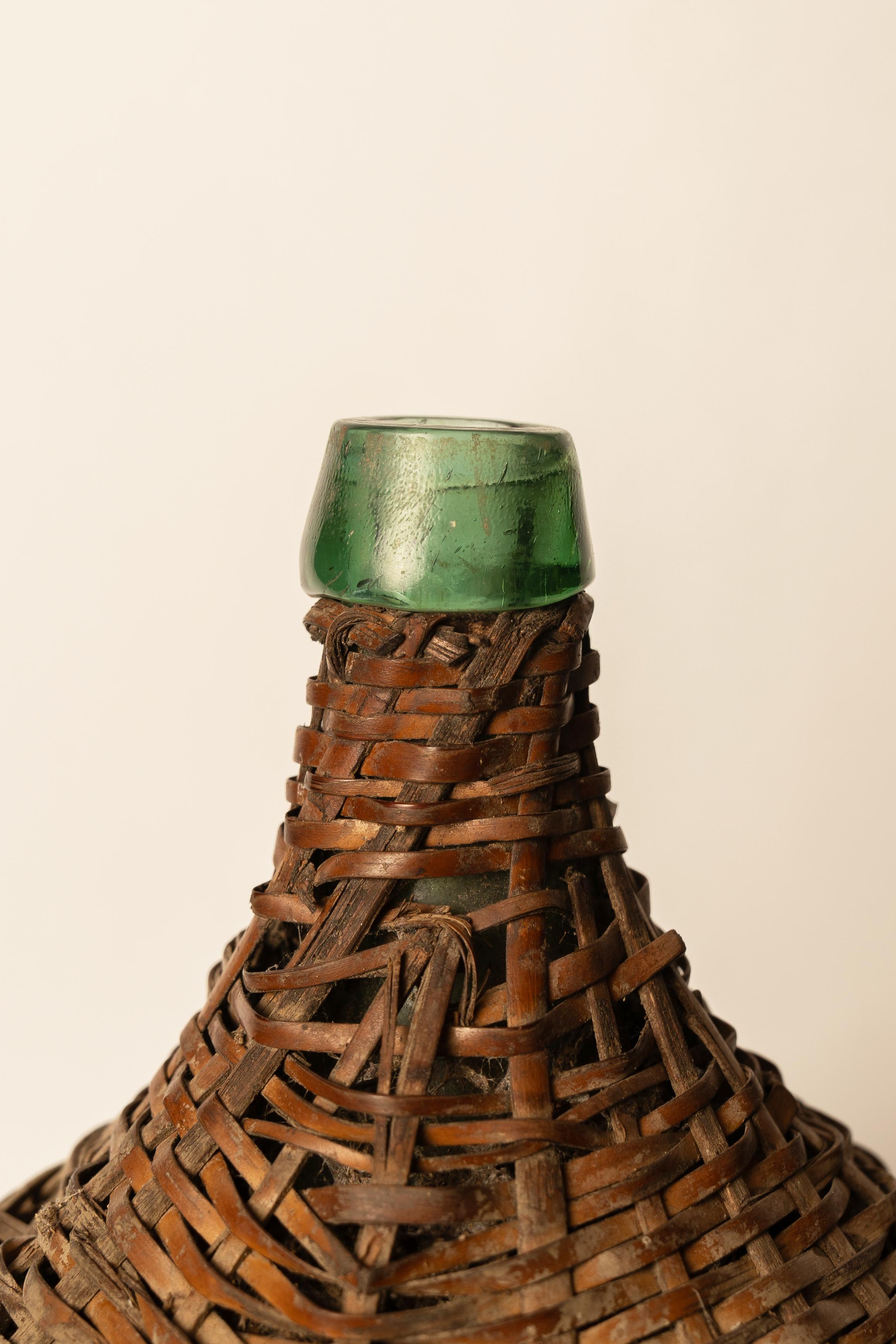 Hand-Crafted Antique Green Glass Carboy with Wicker Cover For Sale