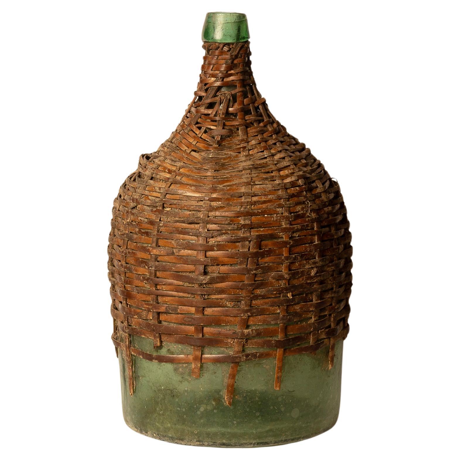 Antique Green Glass Carboy with Wicker Cover For Sale
