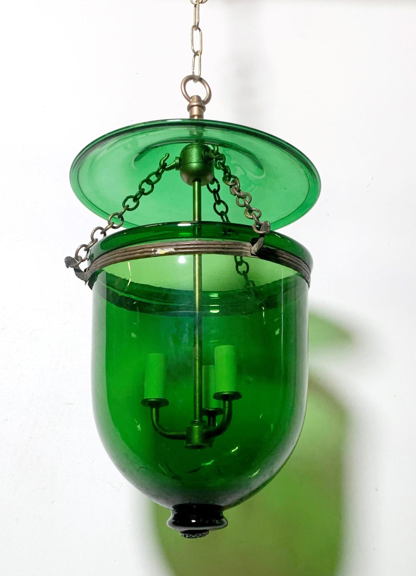 Antique early 20th Century hand blown green glass bell jar pendant light fixture with a matching lid. New brass finished hardware. This can be seen at our 400 Gilligan St location in Scranton, PA.