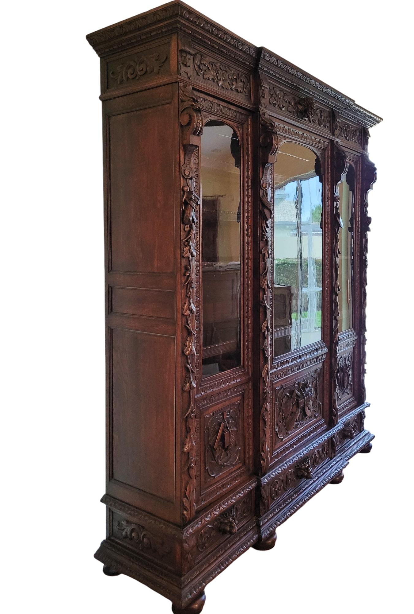Antique Green Man Renaissance Revival oak vitrine, circa 1870s. Most likely Grand Flemish, made for the English market, possibly used to store precious musical instruments or similar items due to its ornamentation. It stands almost 8 feet tall and