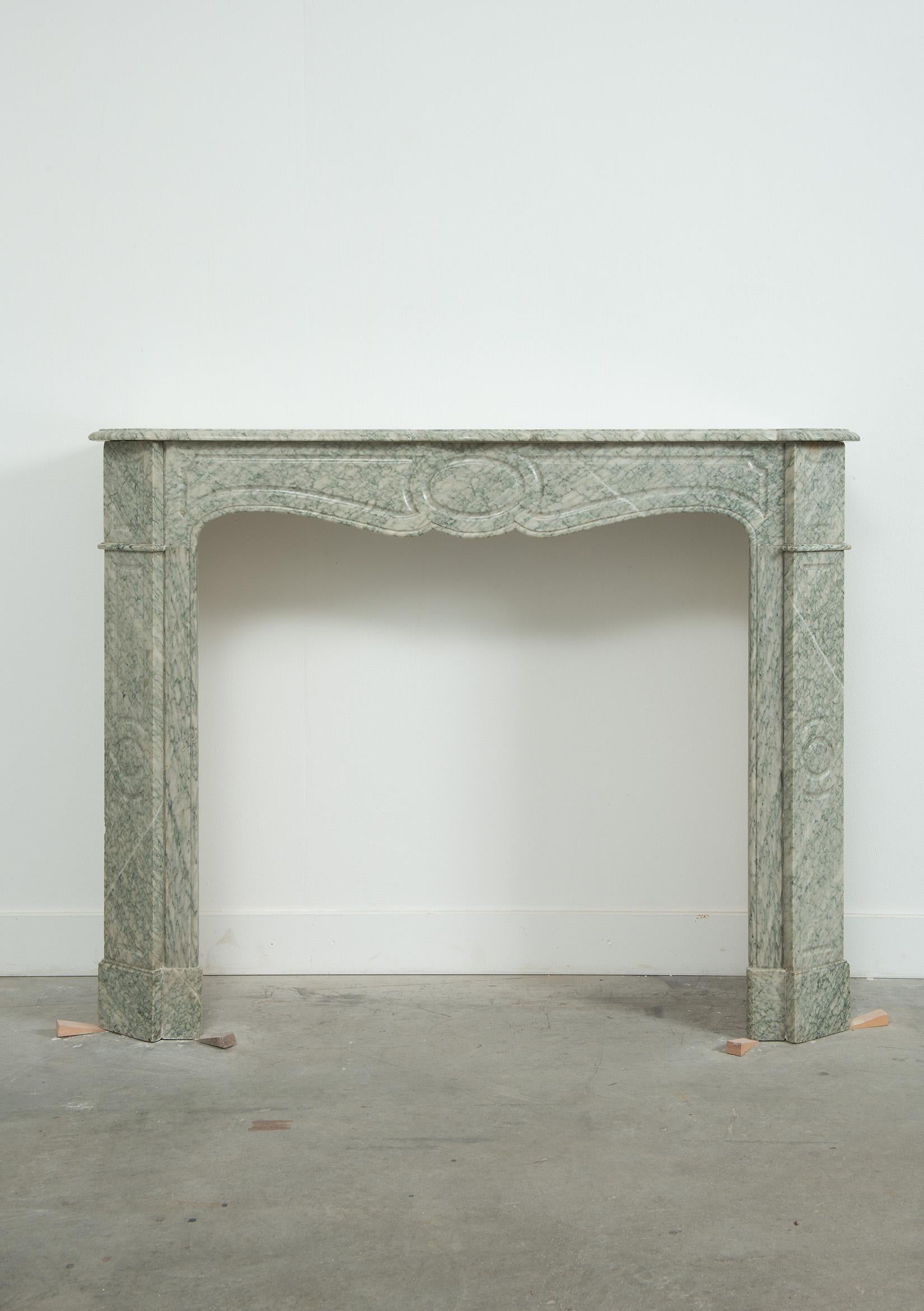 Antique French fireplace amazing green Vert d'Estour also known as Payolle.

Lovely petite Louis XV style fireplace great warm coloring and friendly decorations.
Nice sculpted shelf above a paneled freeze with a central circle between two paneled