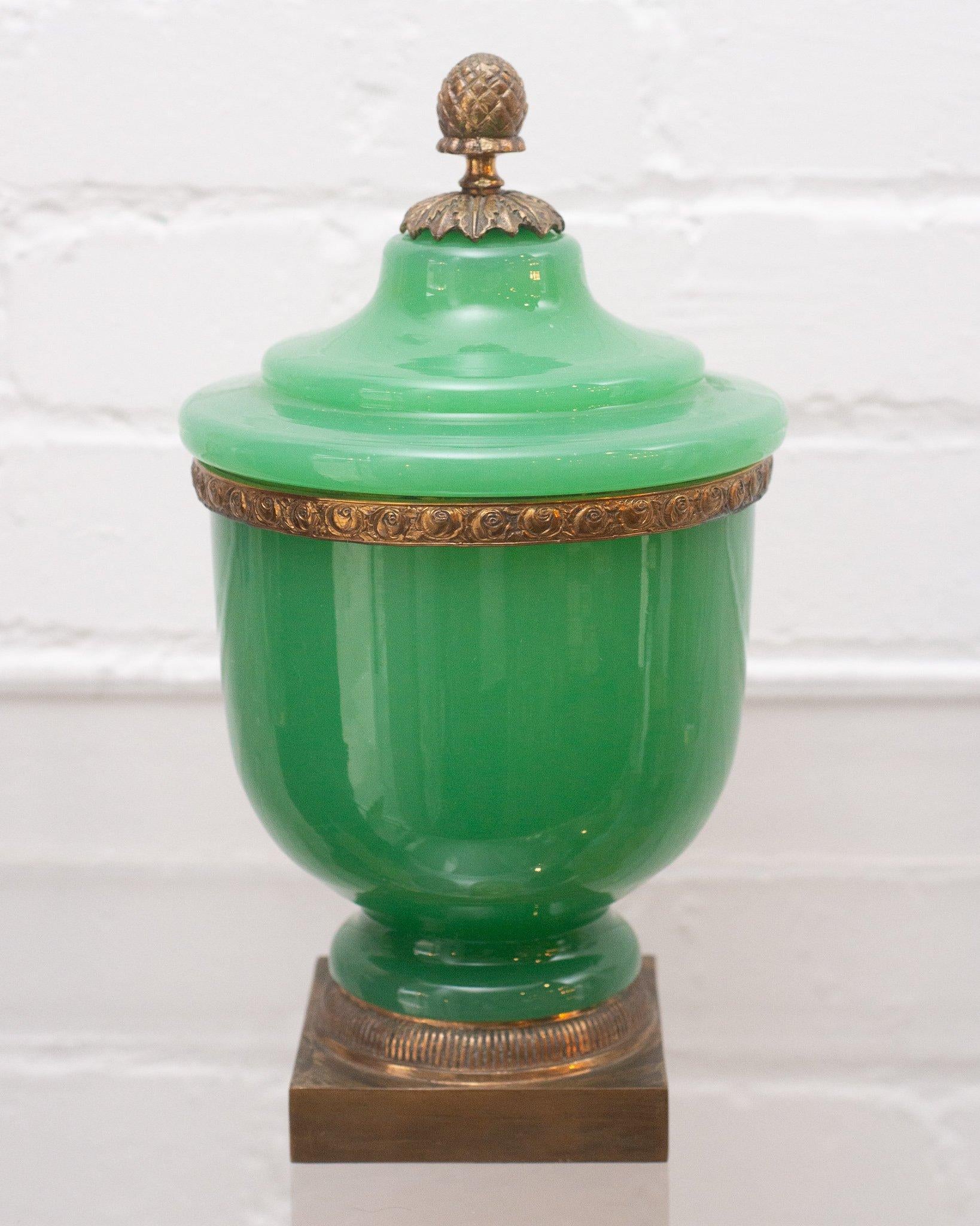 A large and opulent opaline large covered jar in a most unusual shade of green with bronze mounts and an acorn finial. Opaline glass was made in France between the years of 1810-1890. This fine example of the material is extremely sturdy and well