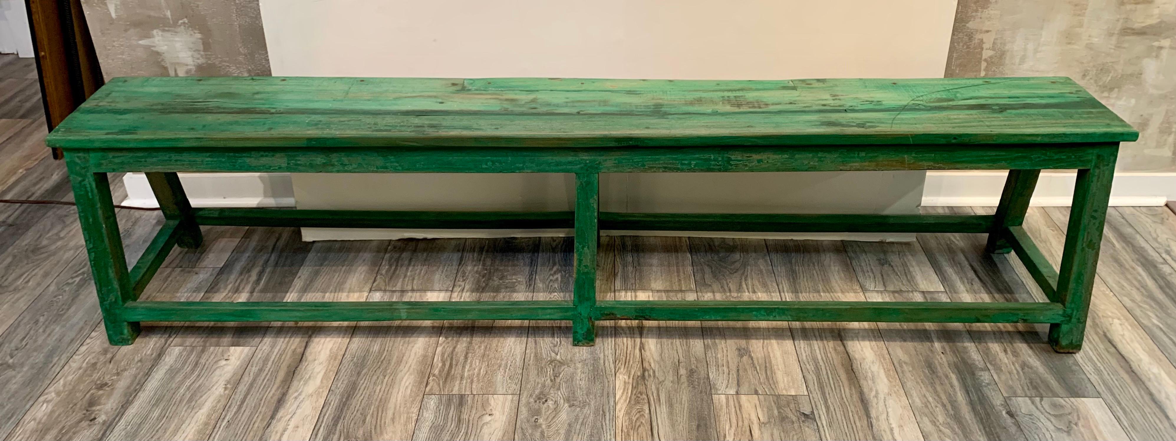 Long antique bench painted in a bright green color will add a punch of color to any room or space.