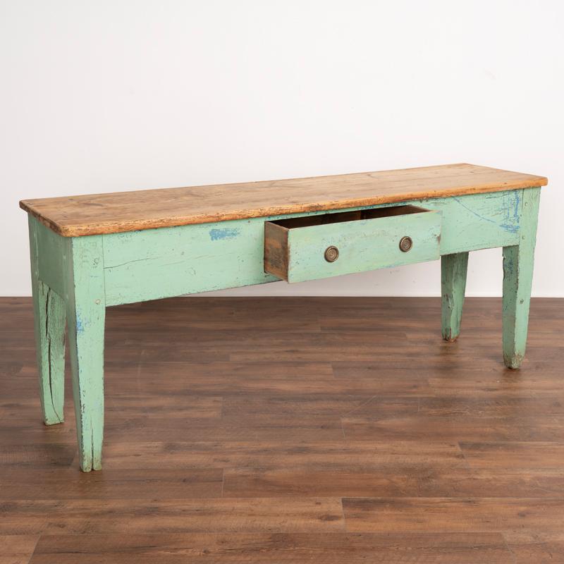 For those who search for a genuine European farm table this long original seafoam green painted console table is a special find. The wonderful, age-distressed green paint of the base is all original with hints of older blue paint underneath, and is