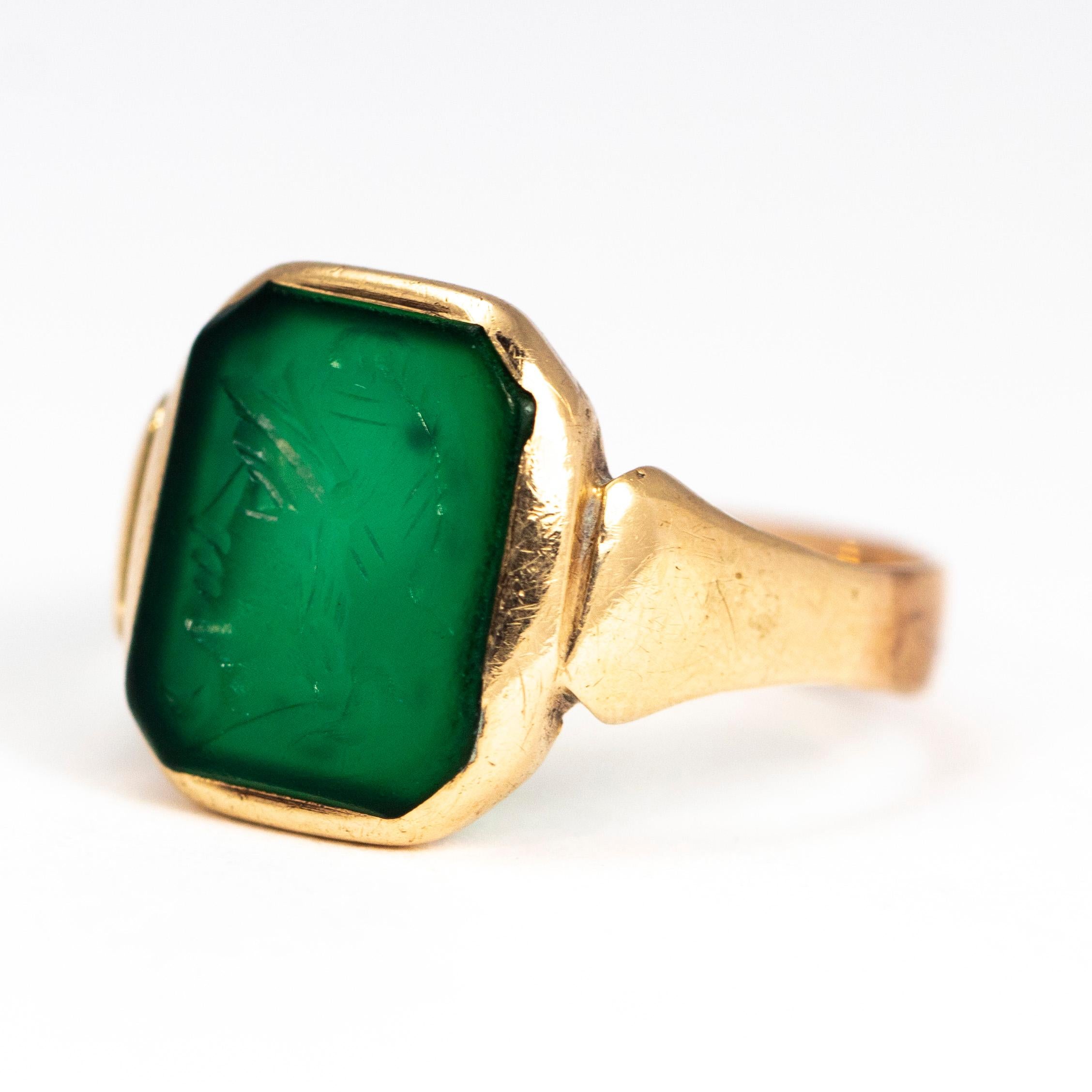 The pop of the green stone next to the glossy gold ring is just gorgeous! The stone has an intaglio of a centurion. 
There is an inscription on the inner band reading ‘18 August 1933’ which was added at a later date. 

Ring Size: R 1/2 or 8 3/4