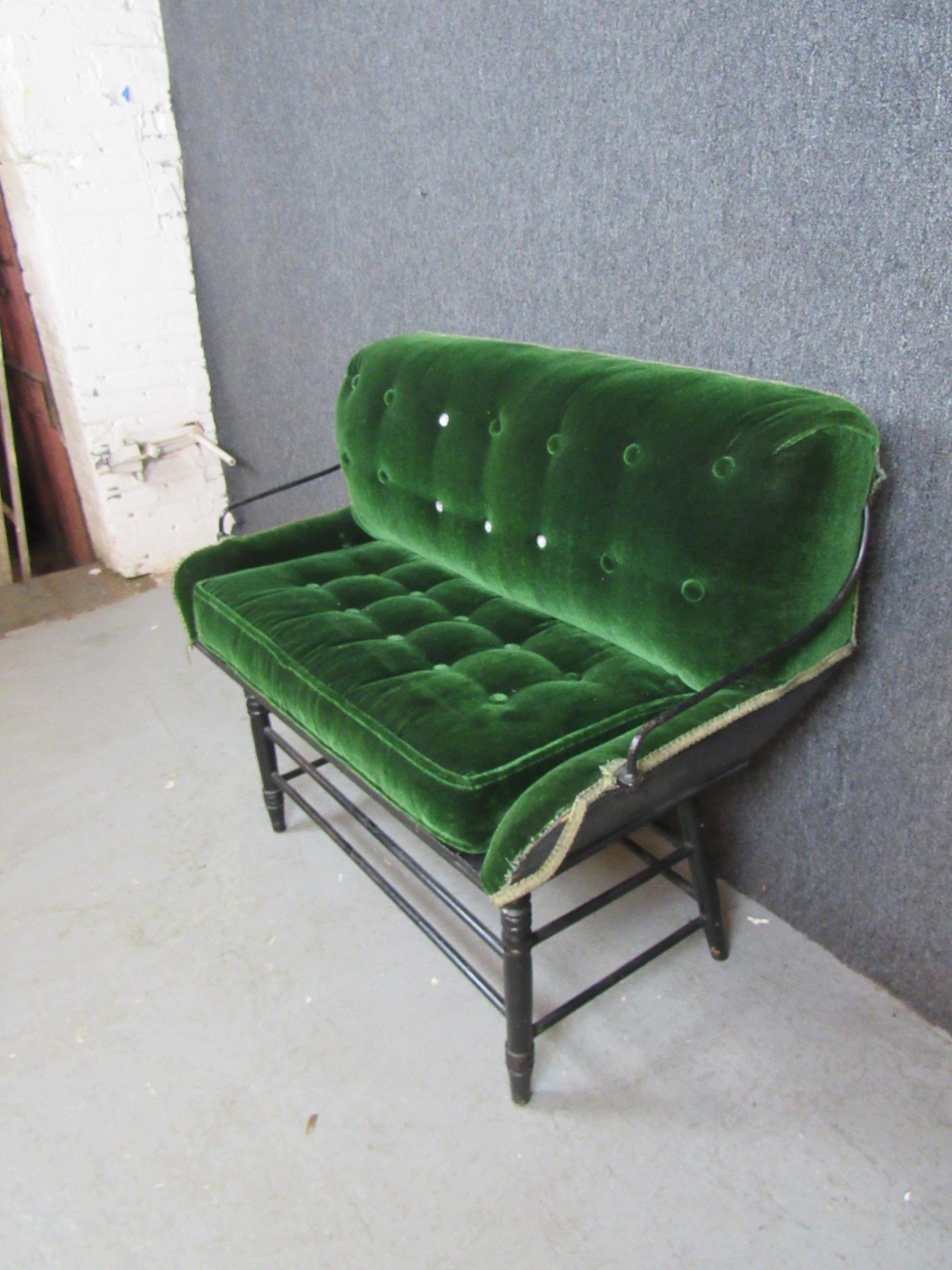 Take a scenic ride from the comfort of home with this endlessly charming antique velvet buggy bench. The genuine carriage bench was repurposed into a cozy love seat with a shabby chic ebonized turned base. The vibrant green velvet upholstery is sure
