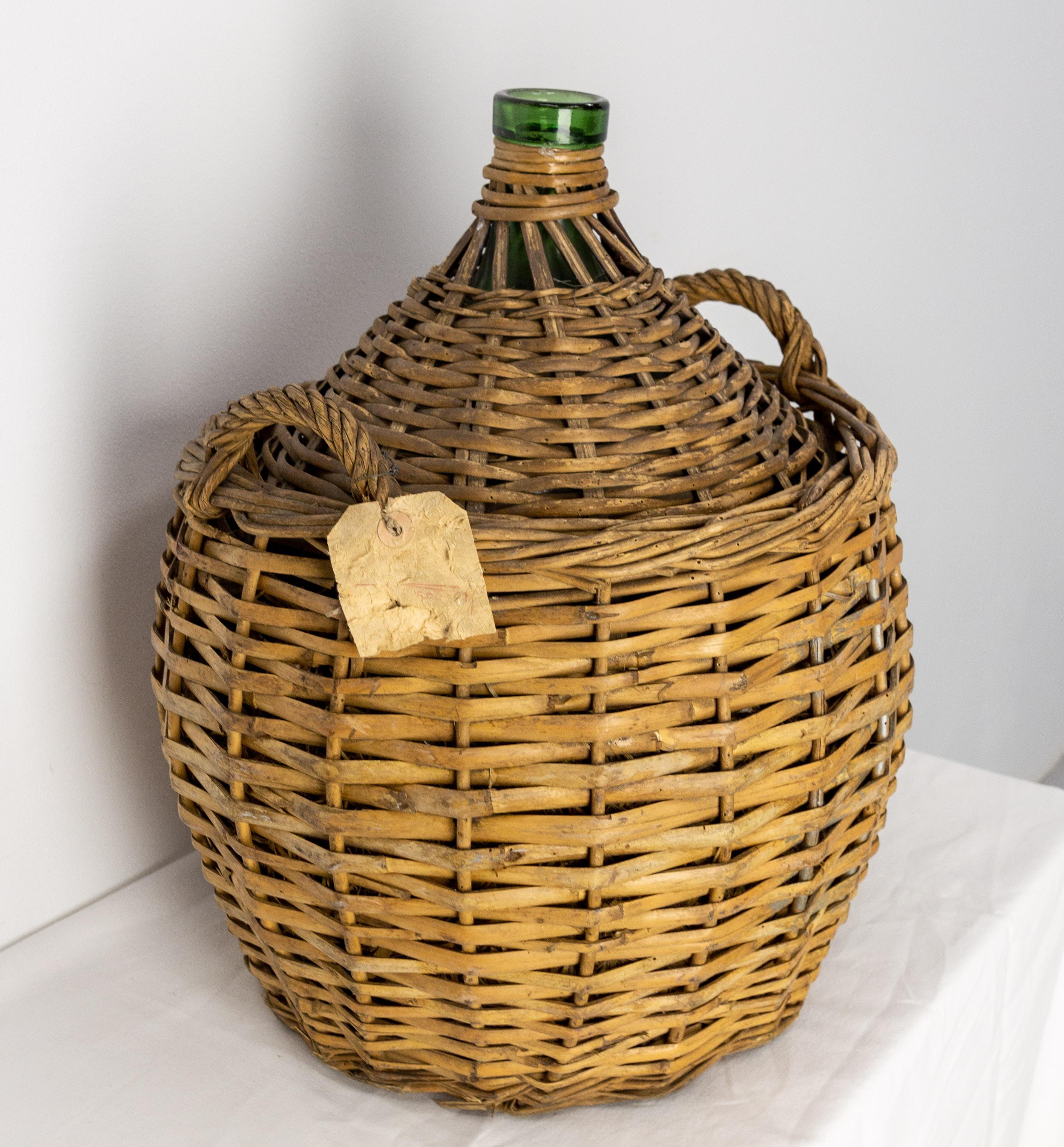 Dame Jeanne or carboy antique glass bottle demijohn.
The carboys were often protected from shocks and temperature variations into a wicker basket. Between the bascket and the bottle, some straw was added (please look on photos).
This king of