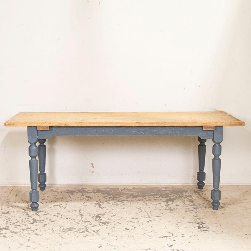 It is the original, dark blue/gray painted finish that catches one's eye in this farmhouse table from the European countryside. The turned legs were decorative for this time period and would have been 
