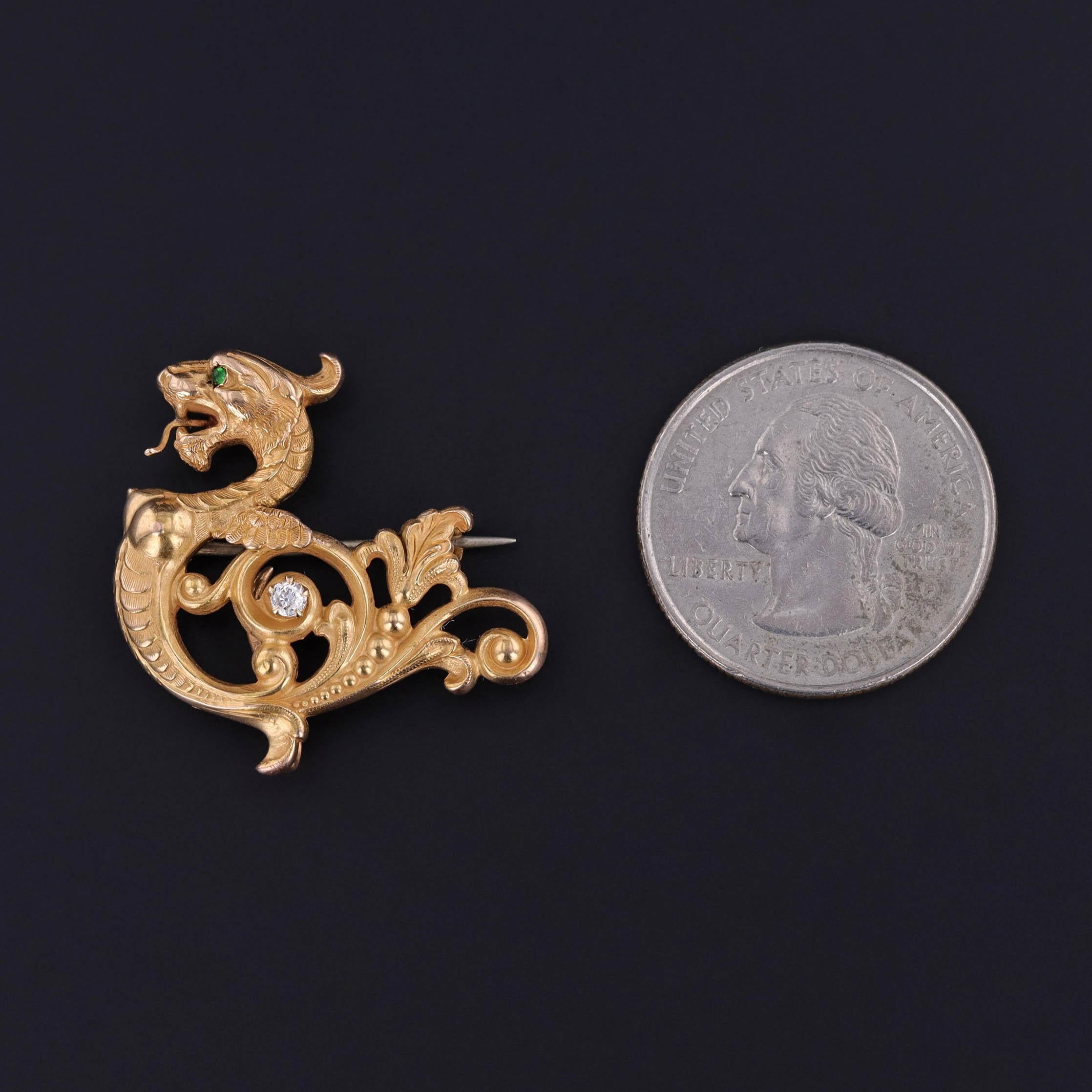 A striking symbol of strength and guardianship, this antique griffin brooch was crafted circa 1910 in rich 14 karat gold by the esteemed American firm Carter, Gough & Co. of Newark, New Jersey—one of the most respected jewelers of the early 20th