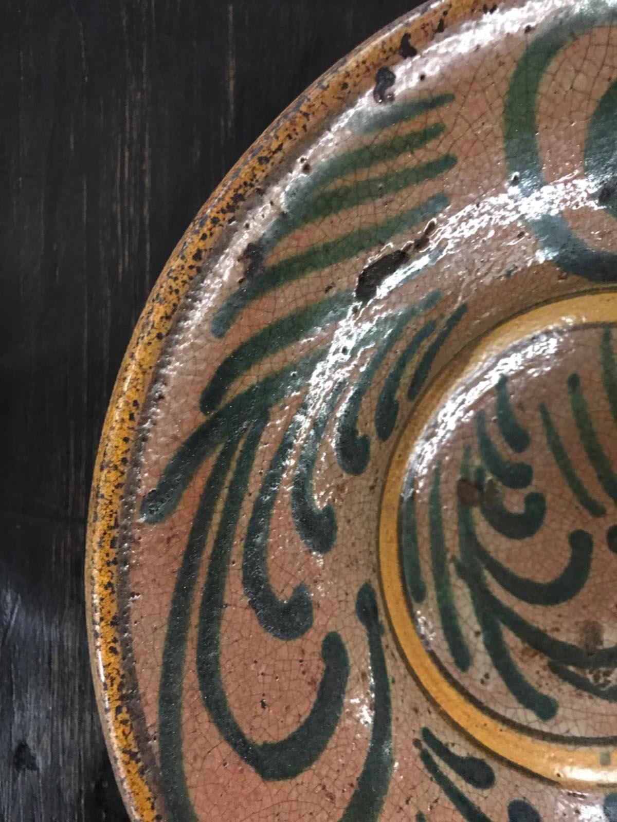 Ceramic plate made by the Montiel factory in Antigua Guatemala. All plates from the Montiel factory are handmade, glazed and decorated and fired in wood ovens. These plates are considered Guatemalan Majolica. Made in the 1930s or 1940s. Each comes