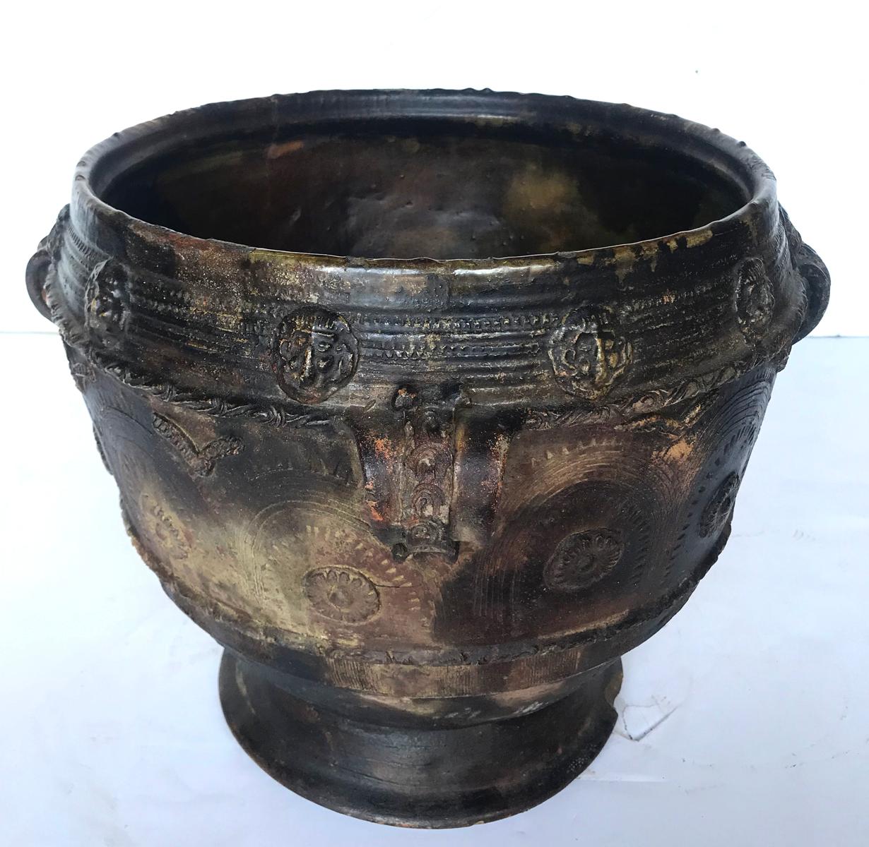 Early 20th century water pot, a Trubal, from the highlands of Central America. Delicate applied pottery decorations of faces surround the outer edge and more applied and carved designs on the body of the piece. Handmade, wood fired, resulting in a