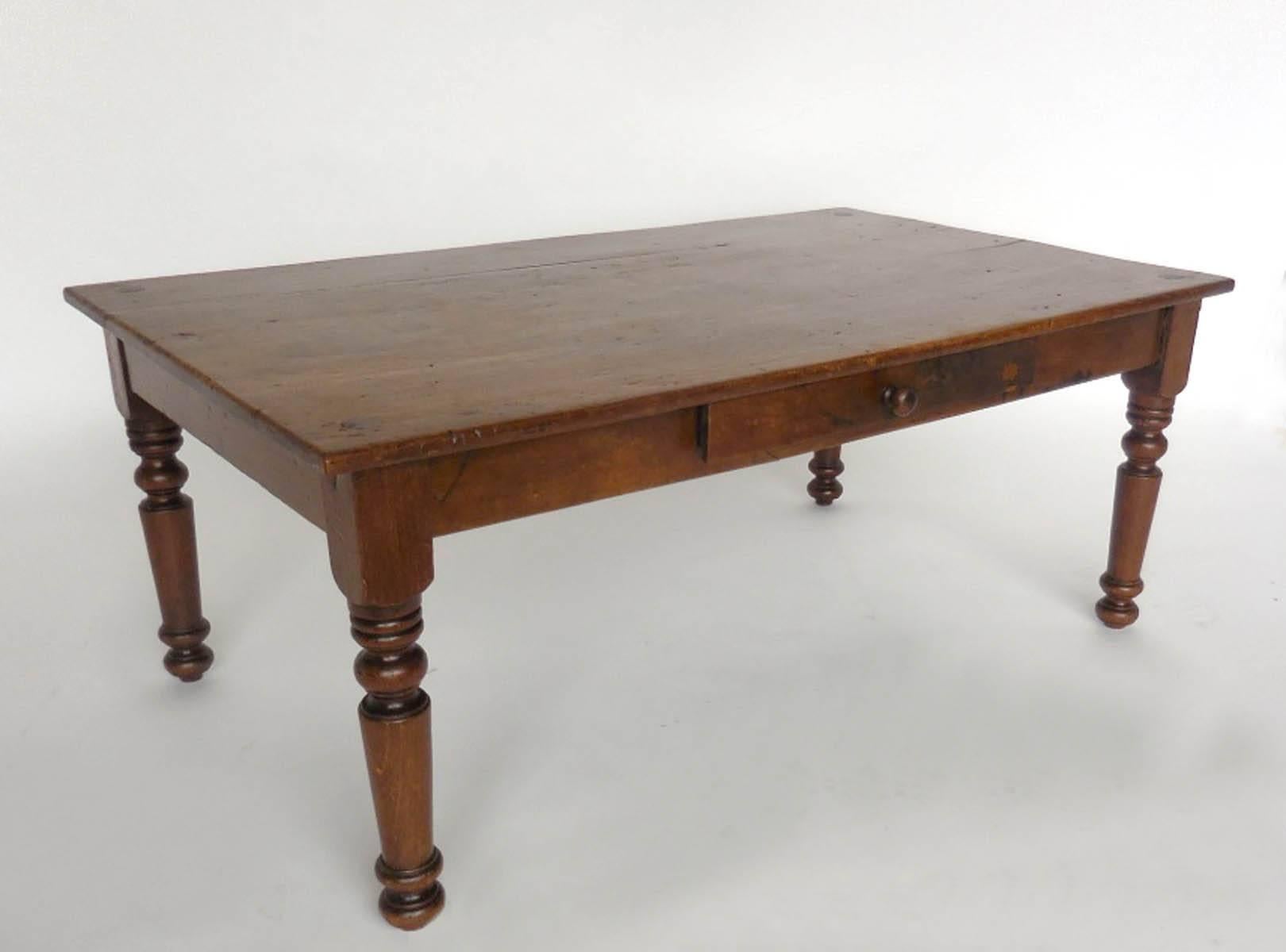 Early 20th century child's bed turned coffee table. Beautiful, simple turned legs, nice patina. Drawer added later on.