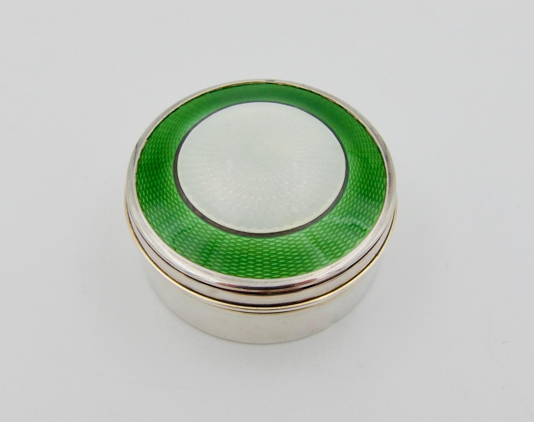 An antique English sterling silver patch or pill box with a domed lid, guilloche enamel decoration, and a gilt interior by silversmith Henry Matthews of Birmingham, date marked for 1911. The lid of the hinged circular box is decorated with a central