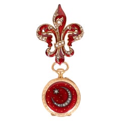 Montre à revers Guilloche ancienne en émail, rubis, diamants et or jaune 18 carats