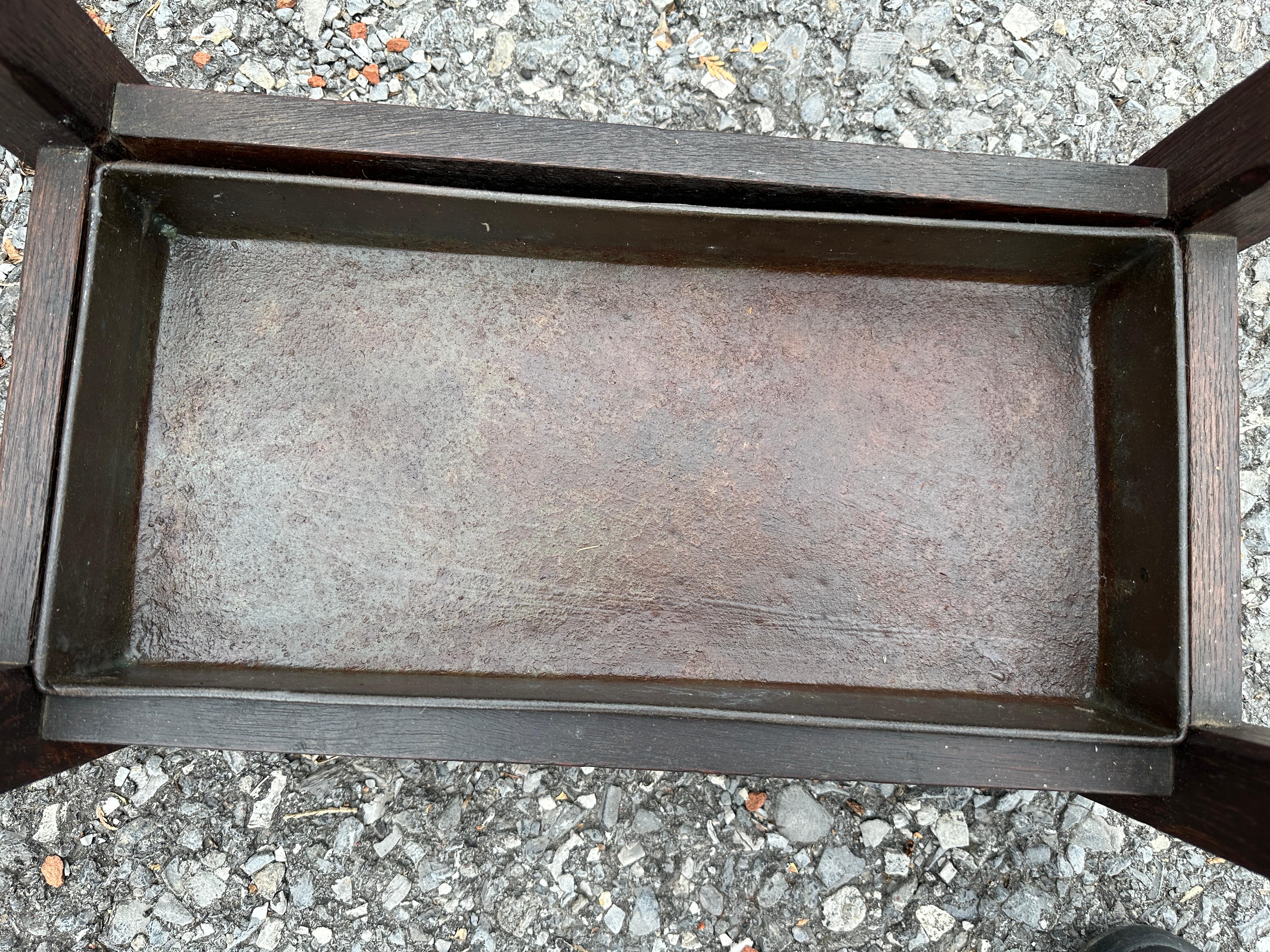 This is an Antique Gustav Stickley Double Umbrella Stand with original metal liner.  There is a remnant of the original Stickley paper tag on the bottom. The stand in in excellent condition.  The metal liner is original and in perfect shape. Sturdy