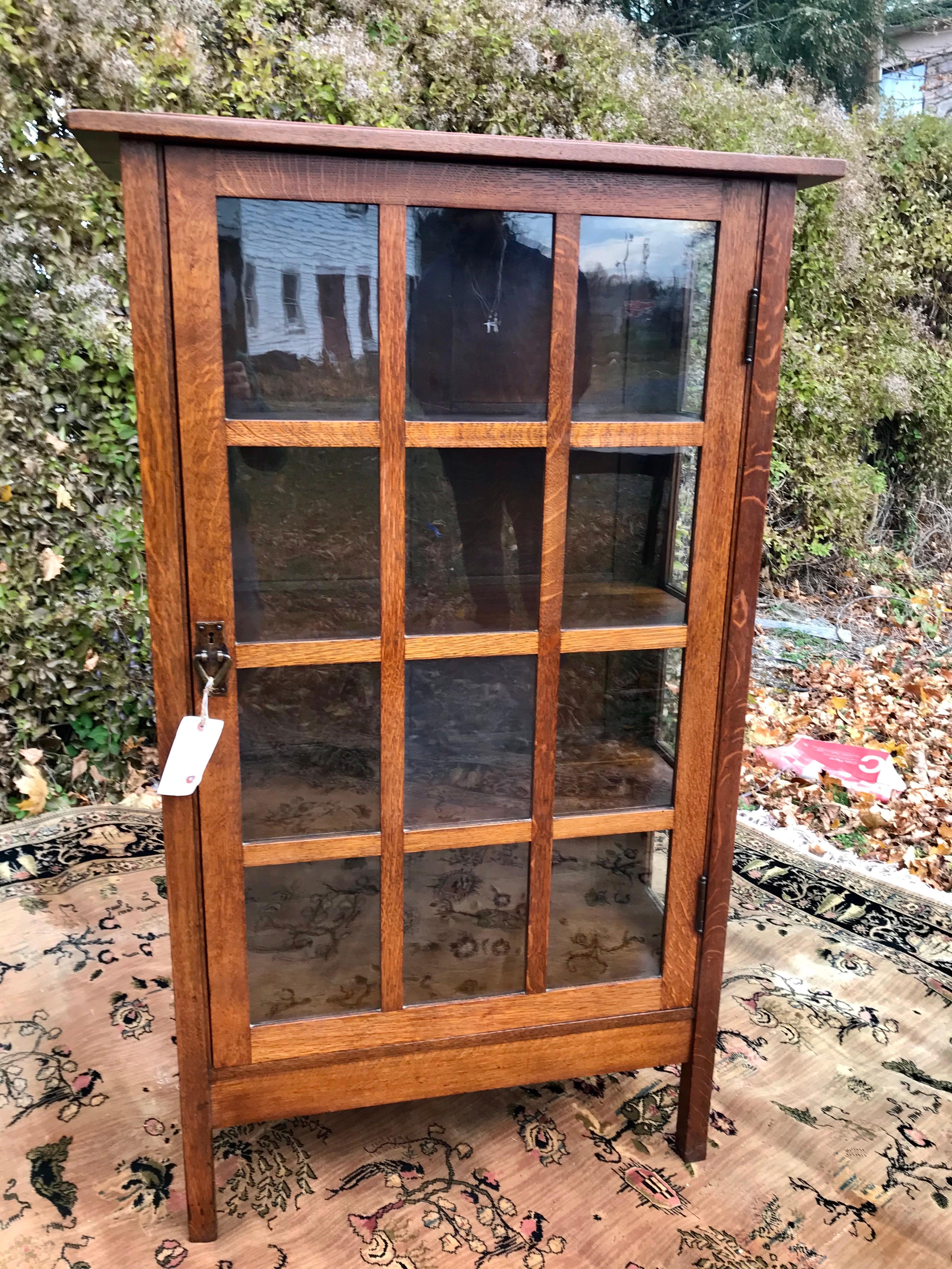 This is an antique Gustav Stickley Model 820 One Door China Cabinet in very good condition. It has the original finish and all hardware is the original hammered bronze. It is STURDY AND STRONG and ready for use in your home or office.

Gustav