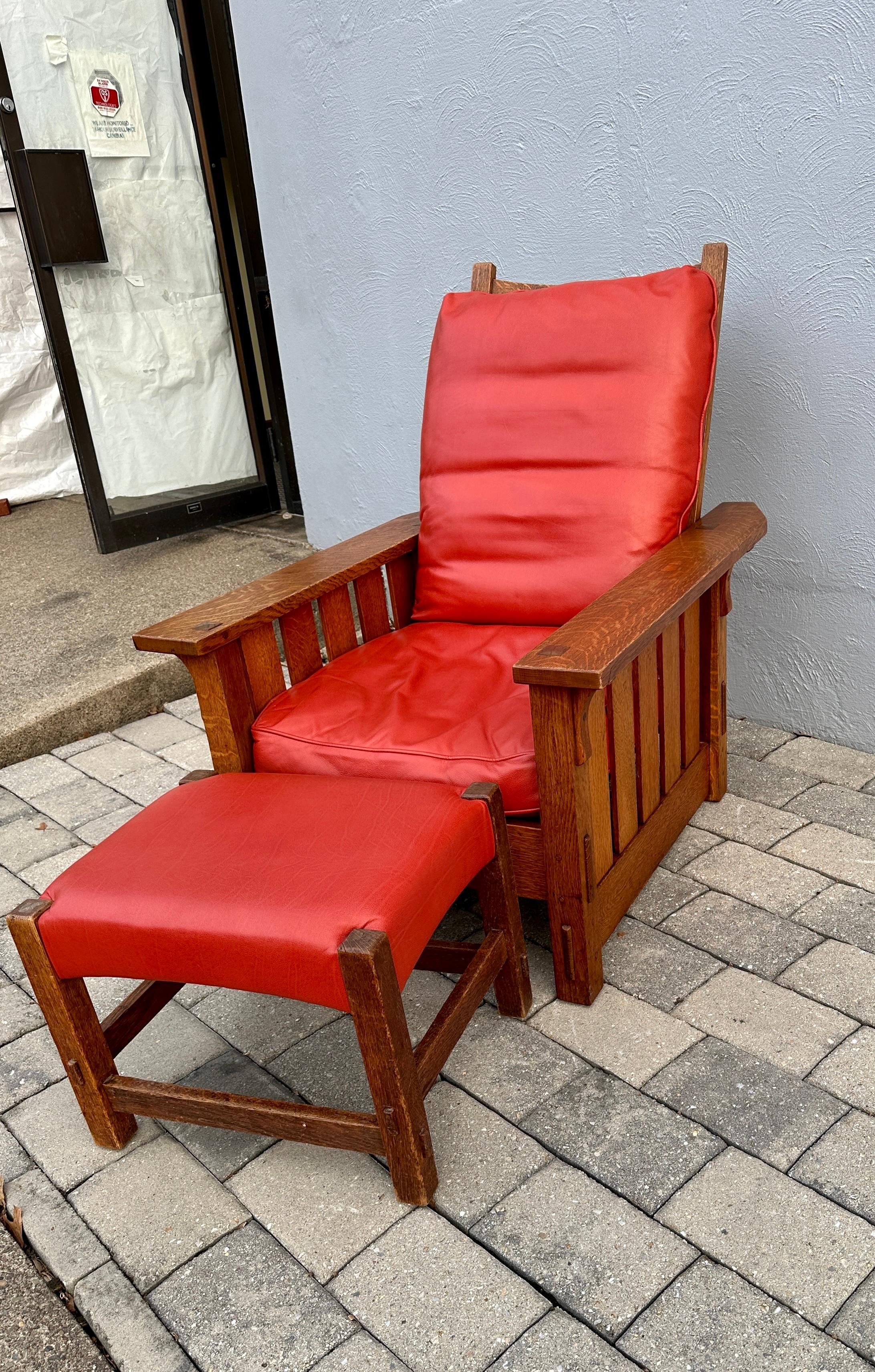 This is an excellent Antique Gustav Stickley Morris Chair (Model 332) and Matching Footstool (Model 300). Made in the early 1900s, the chair has the original golden oak finish.  True Through Tenon Construction on each arm with slats on the sides.
