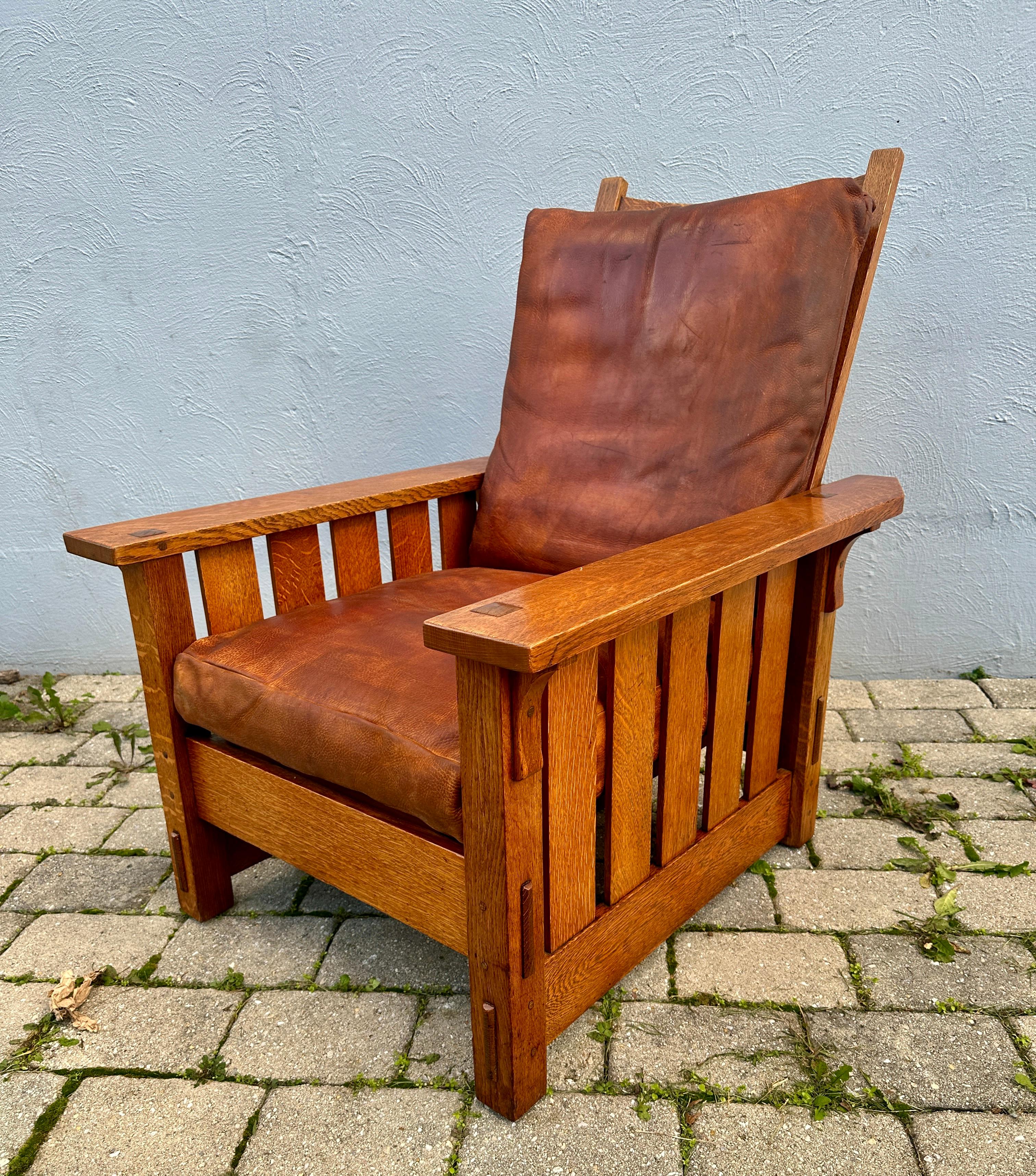 This is an antique Gustav Stickley Morris Chair Model #332.  It was made in the early 1900s and is in very good shape.  It has the original finish and w/ REAL thru tenon construction on each leg, and pinned all around. This chair came from an estate