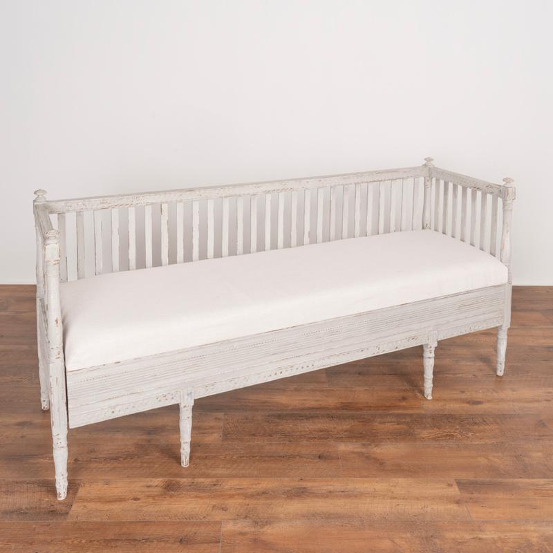 This lovely bench is a wonderful example of Swedish Gustavian craftsmanship with delicately carved details seen best in the close up photos. Turned finials and tapered legs add to the timeless appeal and style. The professional newly applied dove