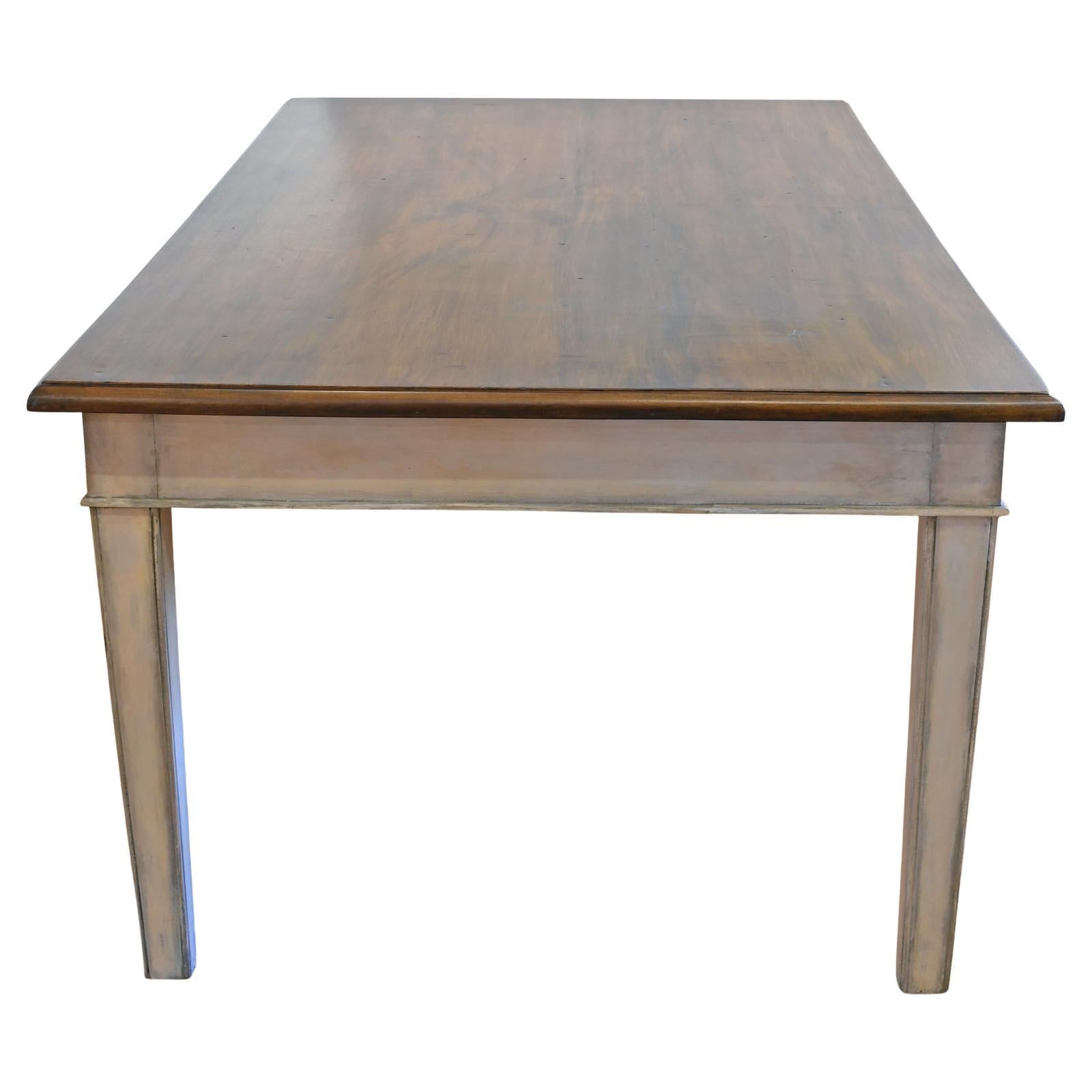 A rectangular dining table with hardwood top & square tappering legs. Base was newly painted in a grey-white Gustavian color with a faux bois tooled & grained top, made to look like walnut (dark umber). Table offers a total of 6 drawers; 3 on each