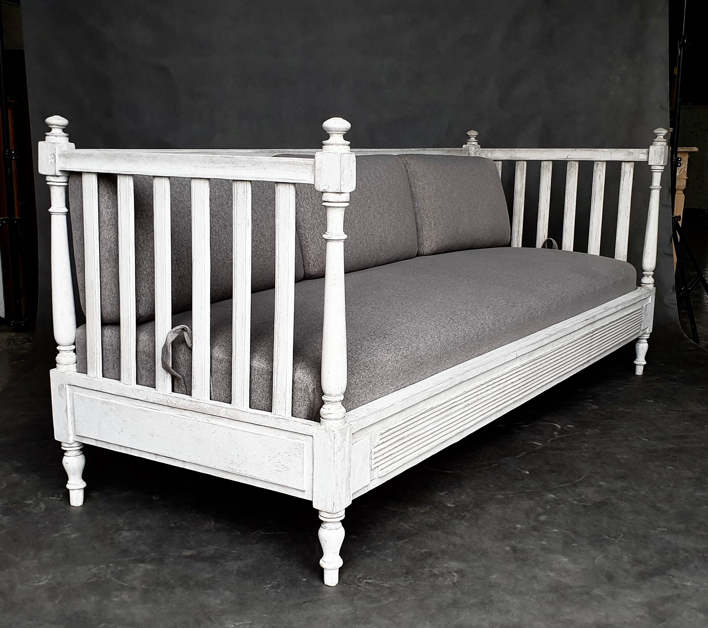 Beautiful and comfortable Gustaviuan Sofa from 1880–1890. Baluster back and sides with turned finials. On the front there are horizontal cutters at the bottom. This settee is in antique white color. This sofa has an original seat and pillows and new