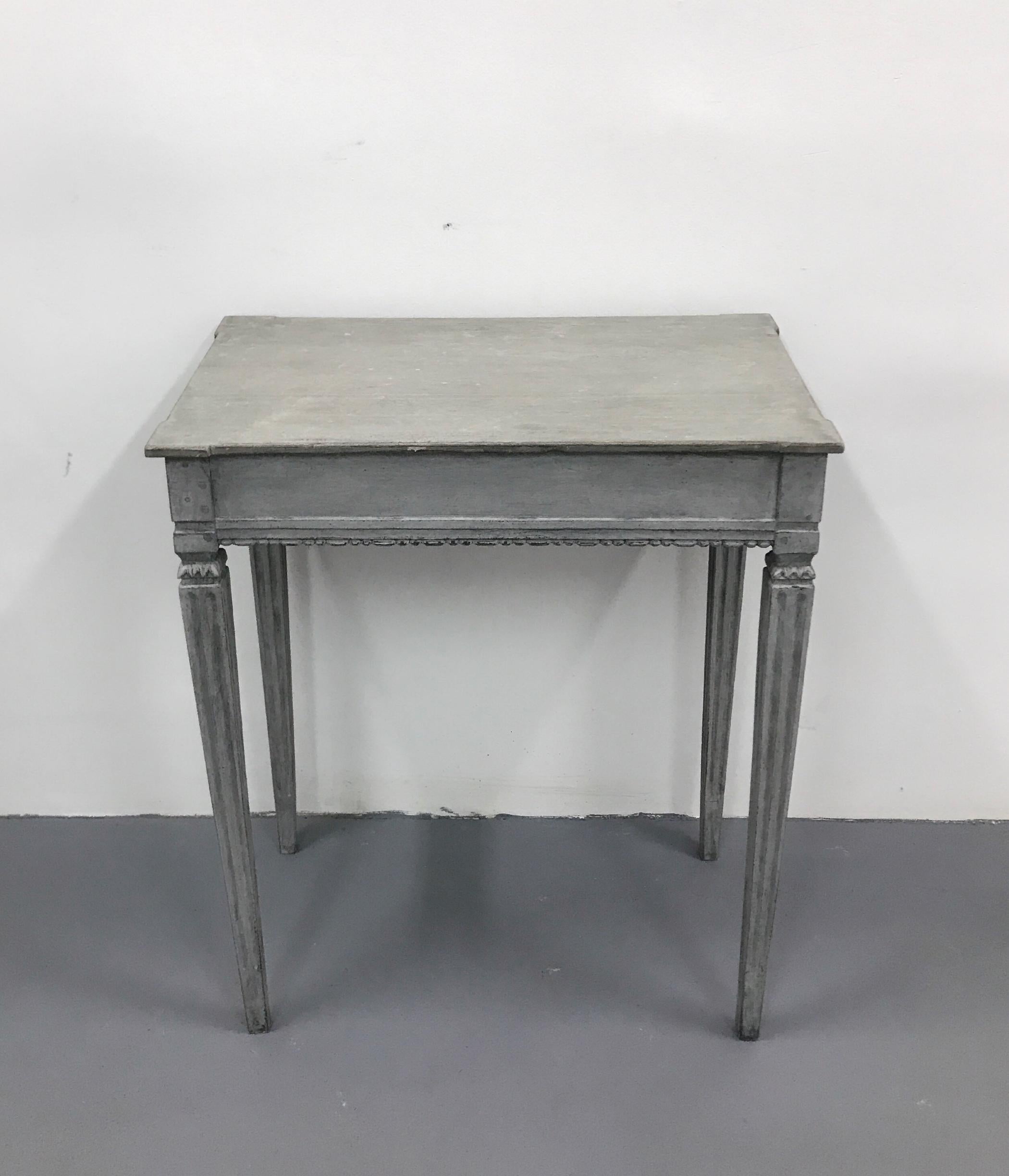 Gustavian style side table with beautiful decoration in a grey and light grey color a table for slender, long legs, tapered downwards. There are vertical cutters on the legs.