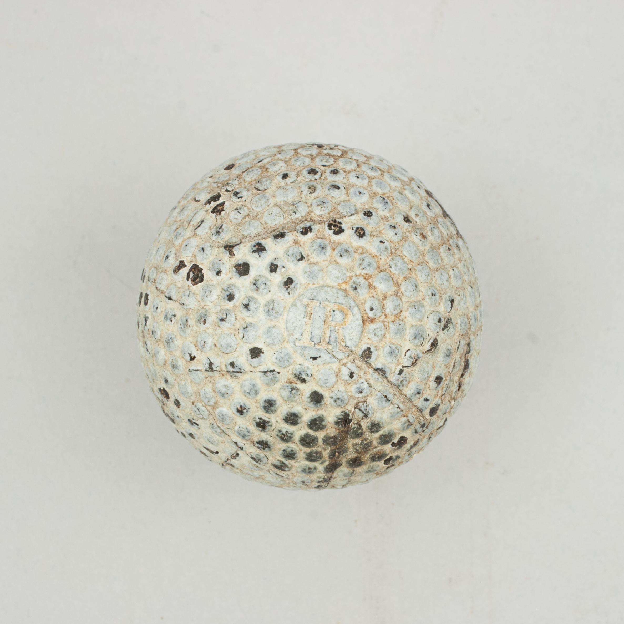 Solid bramble pattern gutty golf ball.
A moulded bramble patterned white gutta percha golf ball in original condition. The 1890's Gutty ball still has most of the white paint but is with some surface marks. The ball is marked 'IR' on both poles and