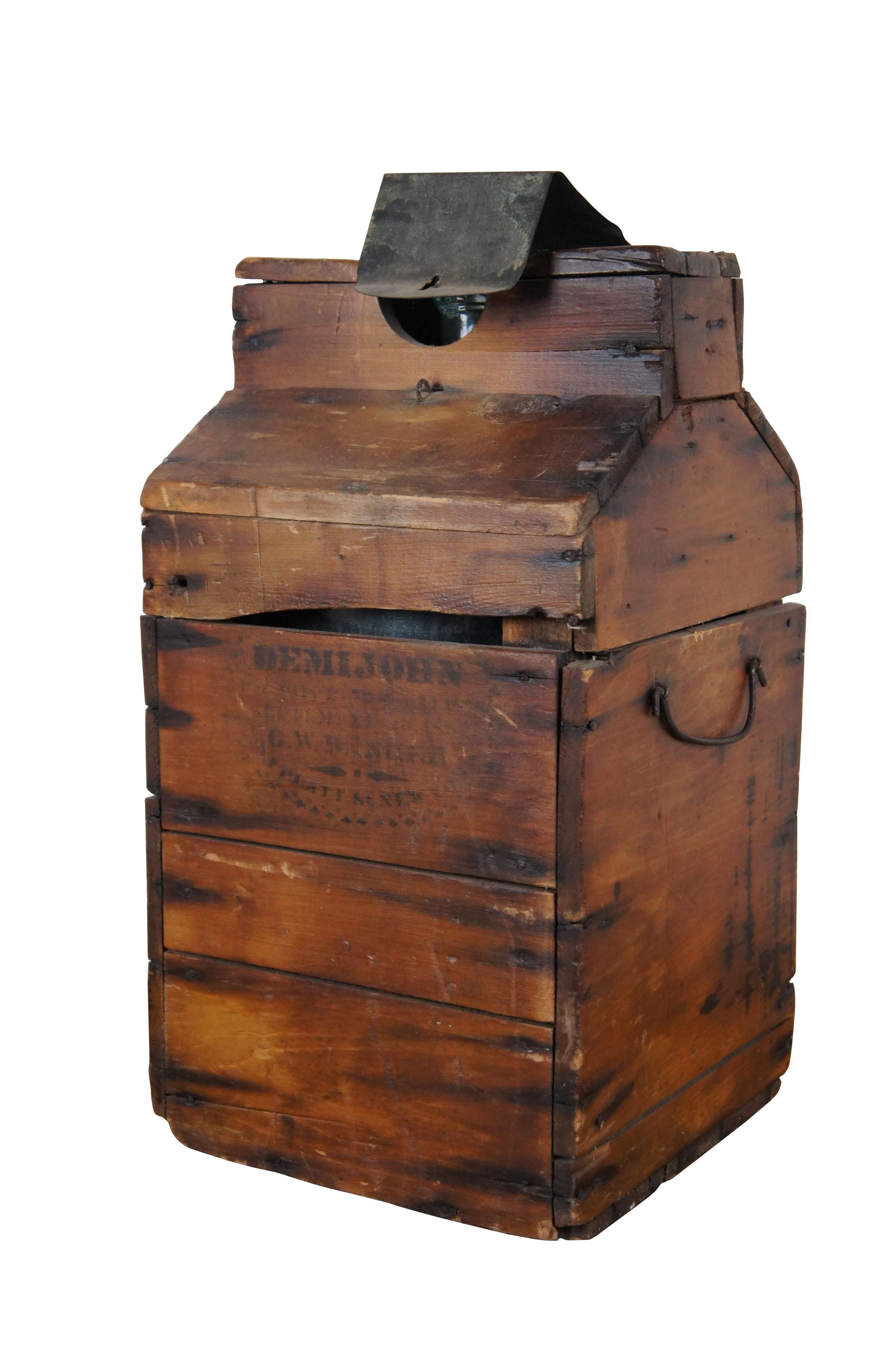 Late 19th century antique demijohn - an oversized wine bottle in pale blue glass with cork stopper - and hardwood tantalus style wine box / storage crate with lockable metal flap on top. Stamped on front G.W. Banker of New York.  Circa 1880s.

