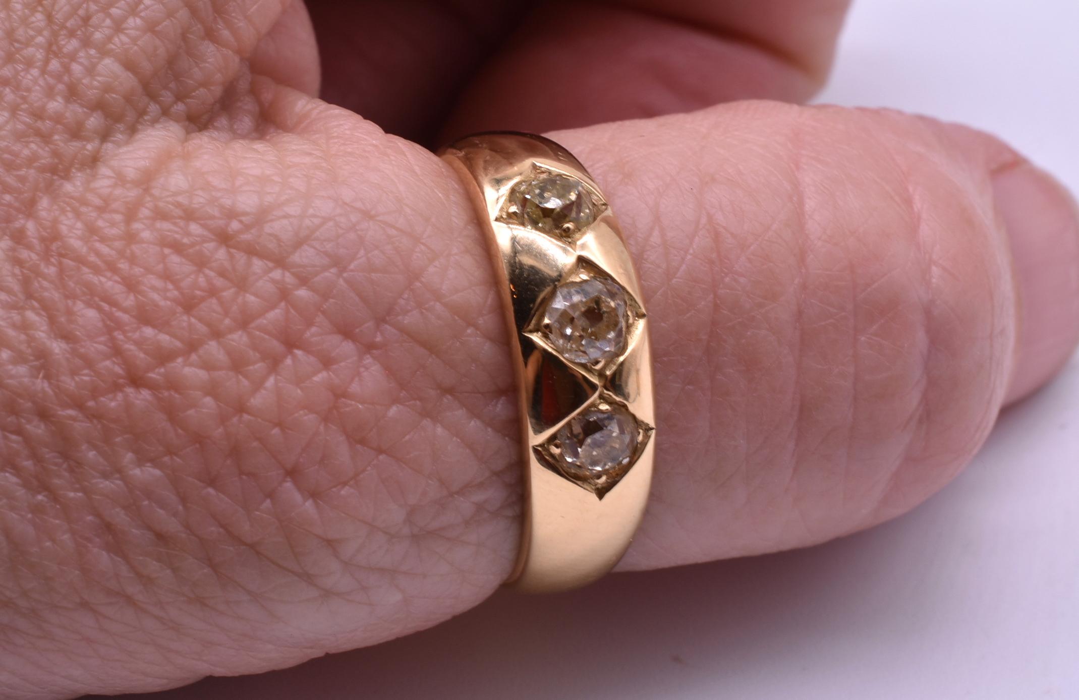 18K large size circa 1900 gypsy ring is a lovely with 3 old mine cut diamonds securely held into etched diamond shapes. Gypsy rings were made with the gemstones set flush with the gold band and is one of the most secure ways to set a ring. Worn by