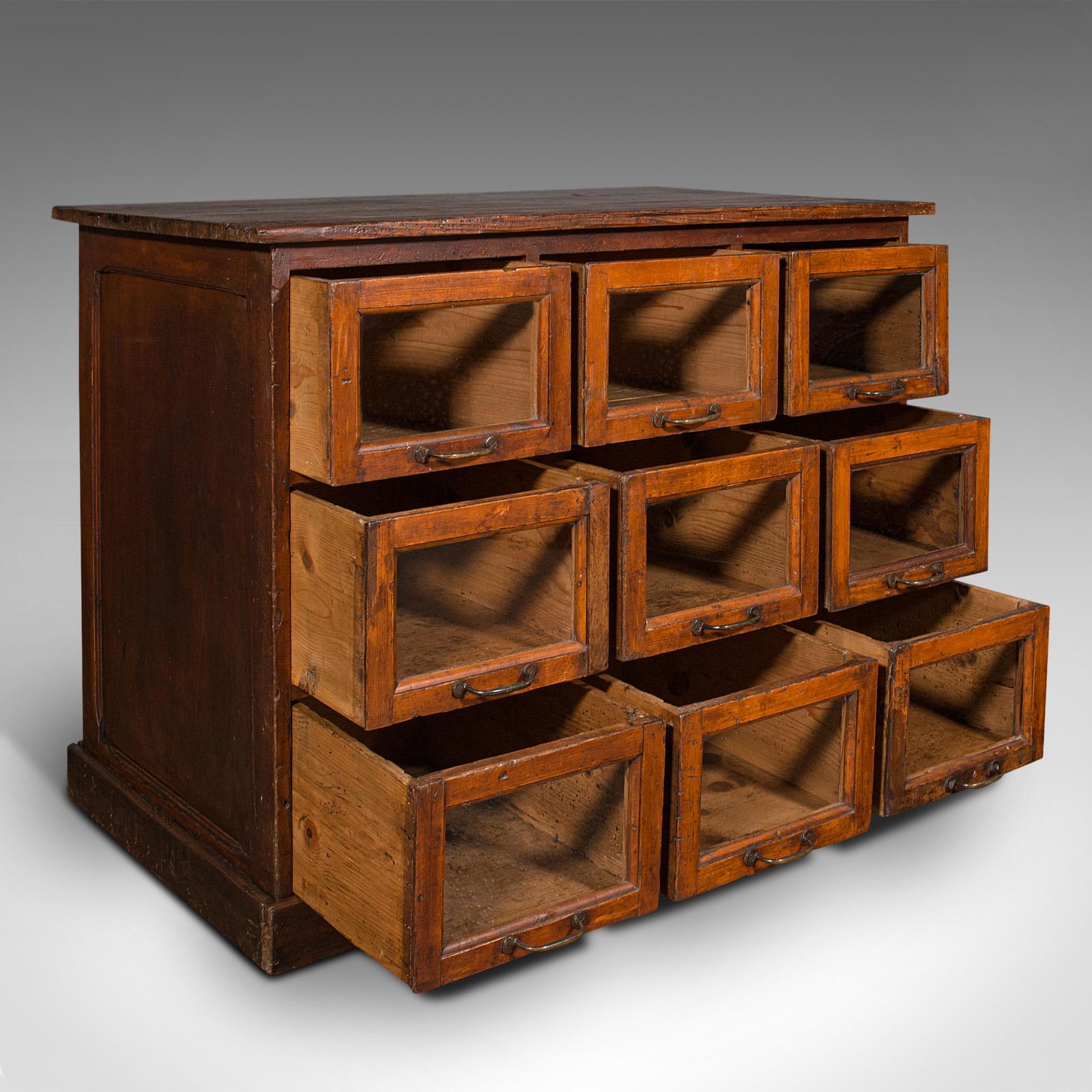 This is an antique haberdasher's cabinet. An English, pine shop keeper's glazed chest of drawers, dating to the late Victorian period, circa 1900.

Superb storage and patination to this useful shop retail cabinet
Displays a desirable aged patina