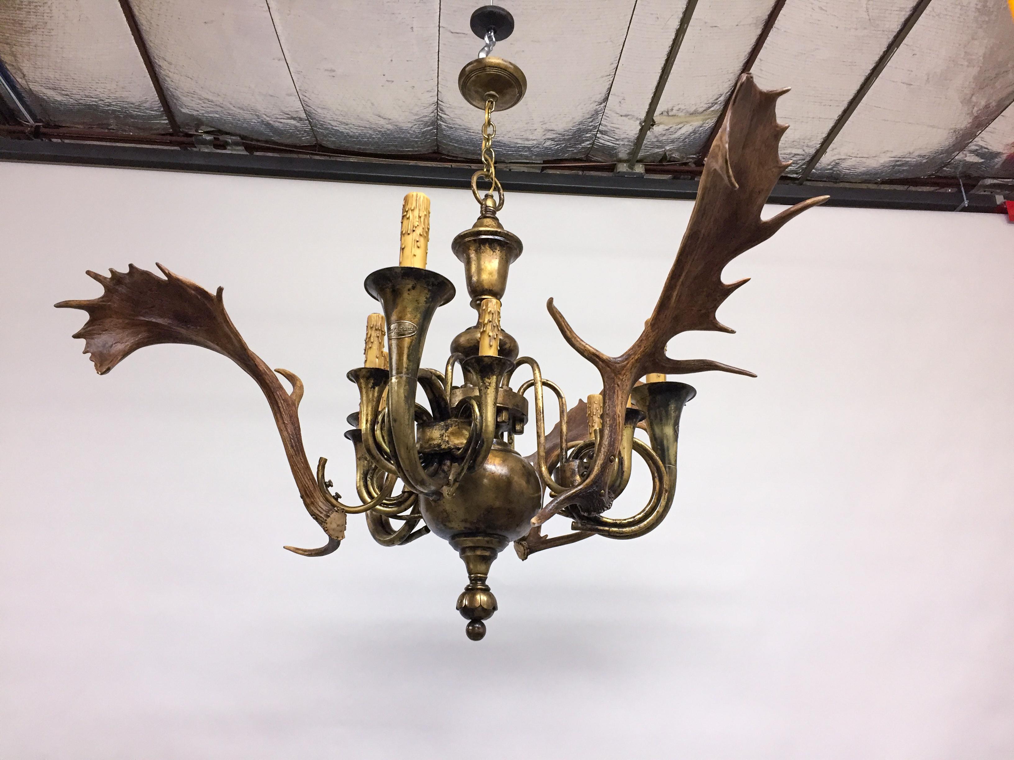 This extraordinary chandelier has been handcrafted with antique hunt horns and Habsburg fallow deer antlers. With nine lights total; three lights come out of the large Fürst Pless original hunt horns (used for red stag) with larger standard base