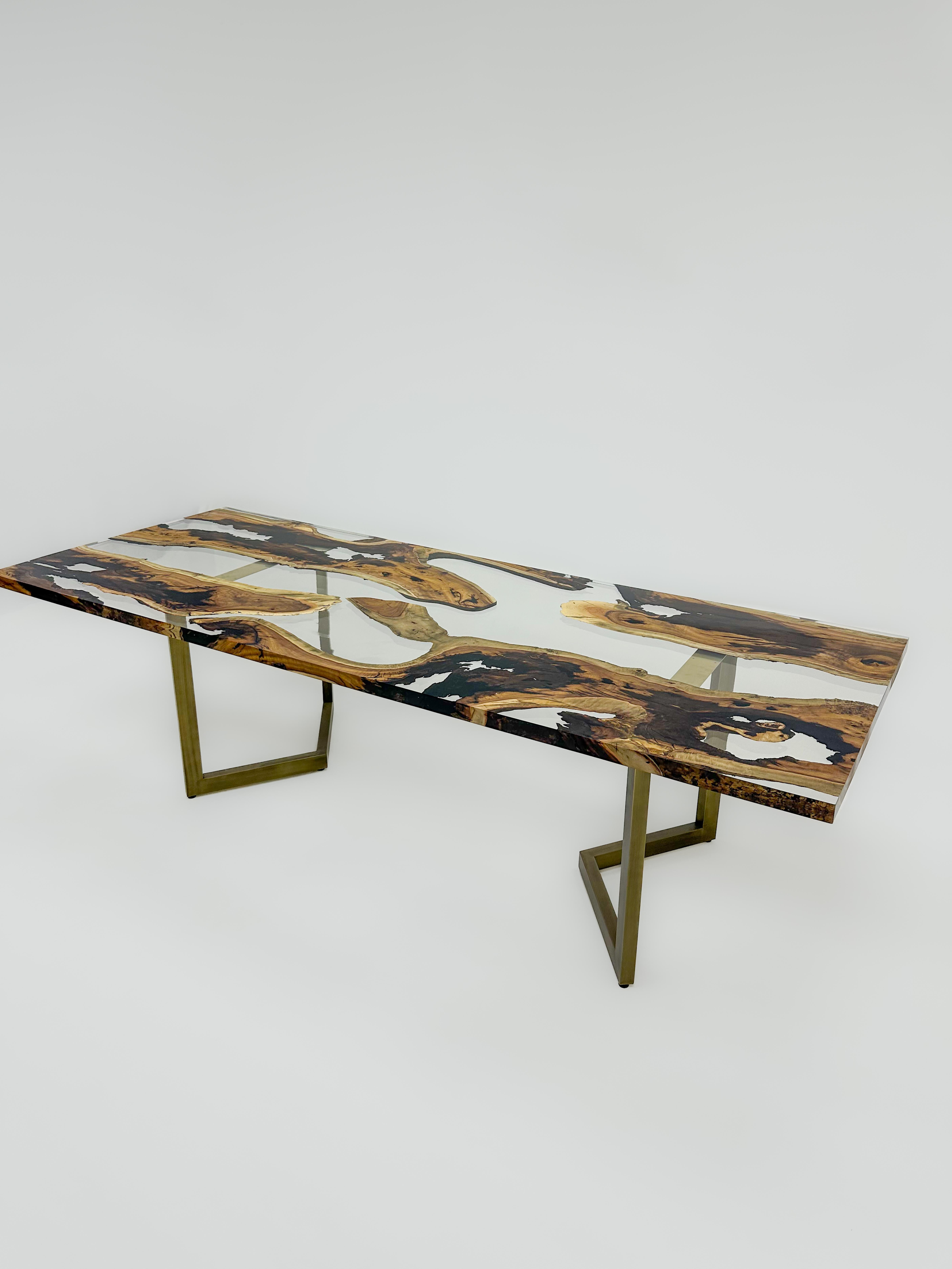 Hackberry Custom Clear Epoxy Resin Dining Table 

This table is made of 500 years old Hackberry Wood. The grains and texture of the wood describe what a natural walnut woods looks like.
It can be used as a dining table or as a conference table.