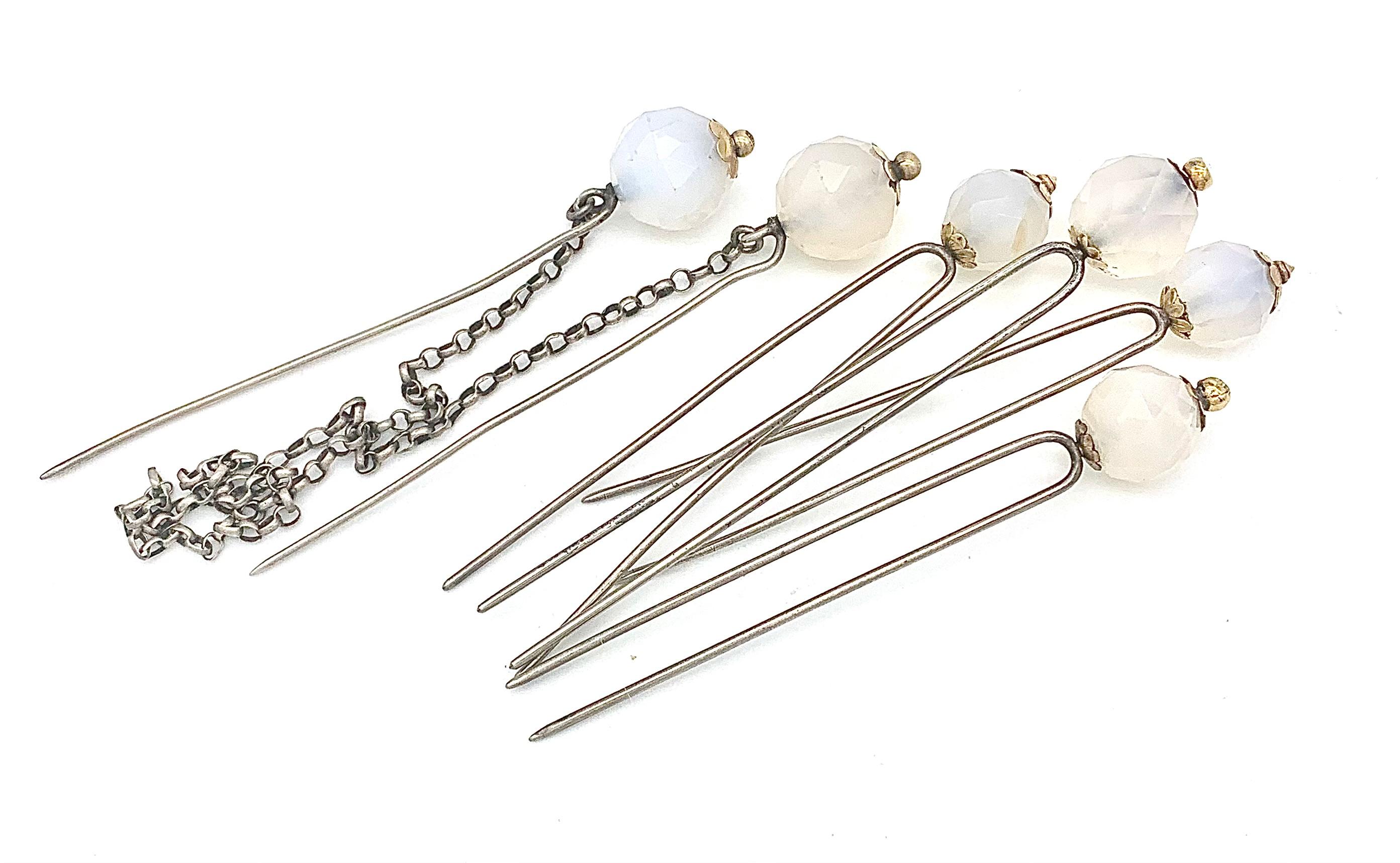 These unusual hair ornaments come as a set of four haipins with two prongs each and two pins with one prong each connected by a silver chain. All the pins are mounted with natural colour facetted chalcedony beads. The tops of all beads are decorated