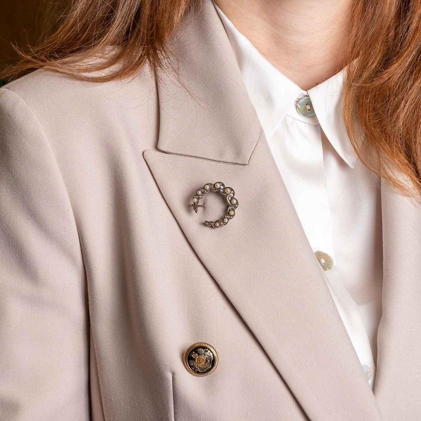 Gorgeous antique half moon crescent brooch. Set in silver and gold with rose cut diamonds and cultured pearls, from the early 1900s circa. In the back there is a small hook which allows for the brooch to be used also as a pendantif.

Highlights
-