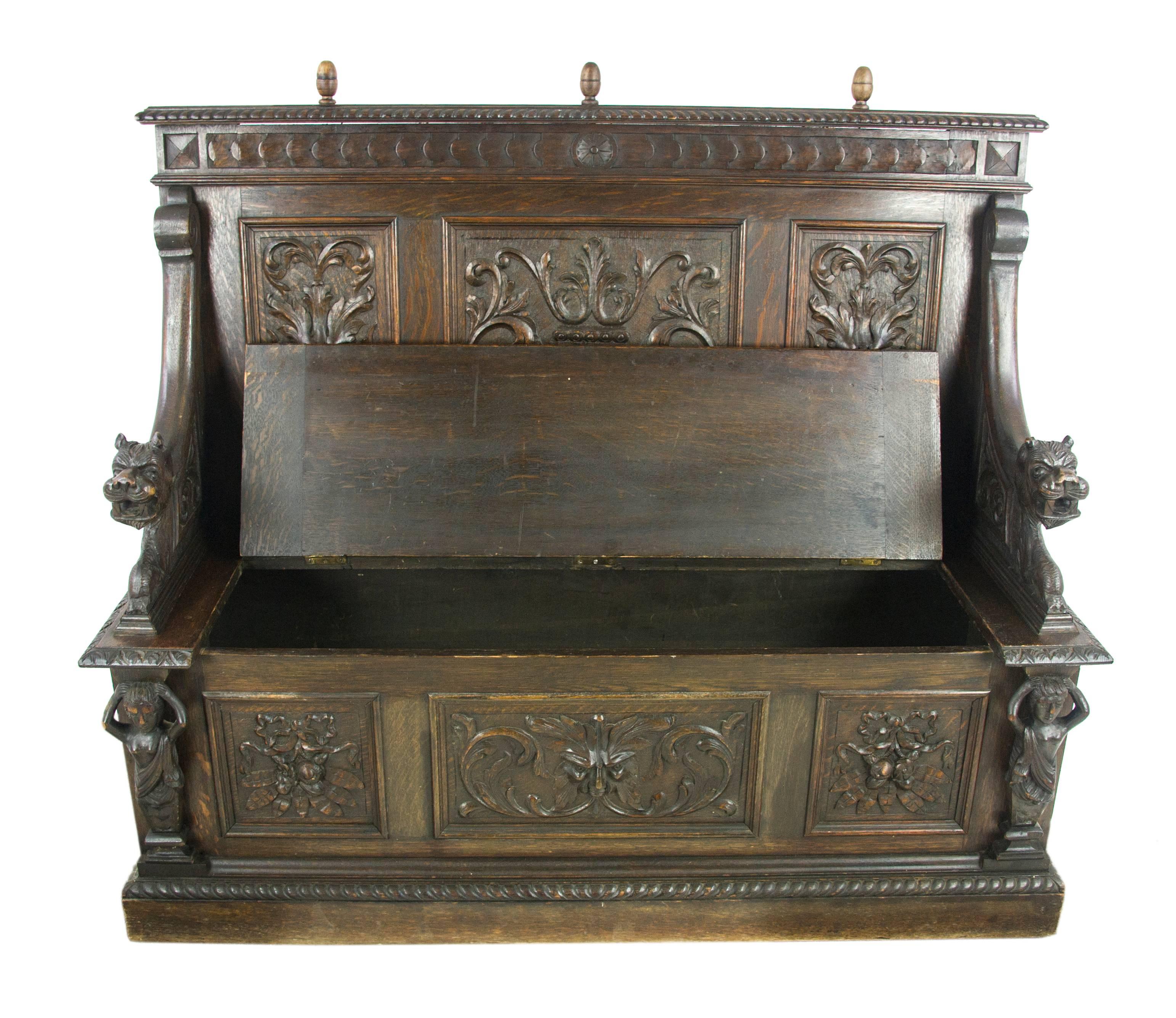 Antique Hall Bench, Entryway Furniture, Carved Oak Settle, Lift Up Seat, Scotland 1880, Antique Furniture, B1003

Scotland, 1880
Solid Oak Construction
Original Dark Oak Finish
Carved Top Rail with Three Finials
Greenman Mask to the back
Base