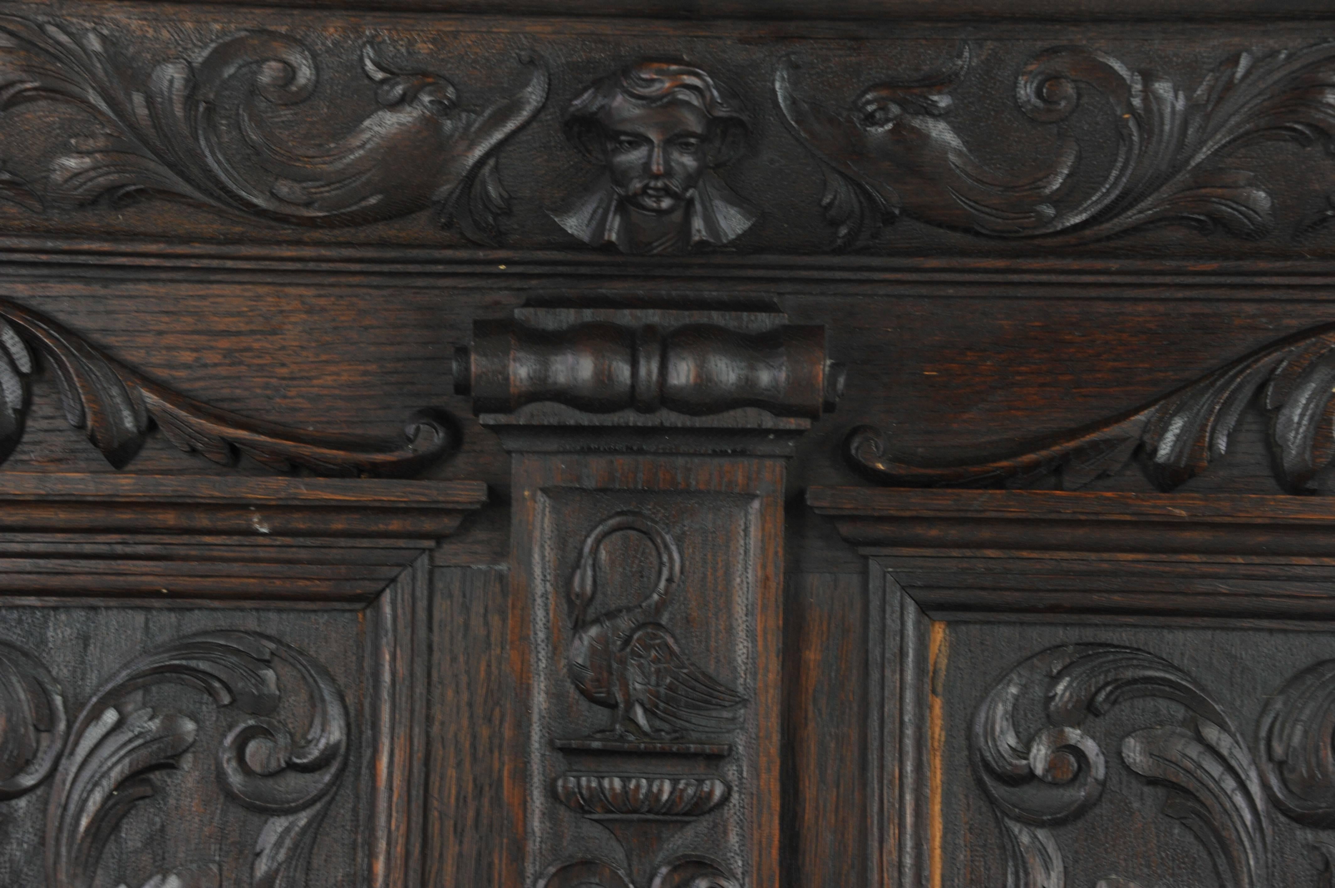 Antique hall bench, carved oak settle, lift up seat, A. Gardner of Glasgow, B1004

Scotland, 1870
Solid oak construction
Original dark oak finish
Back profusely carved with scroll swags
Crowellian style mask
Swan and putti and lions heads
Base has