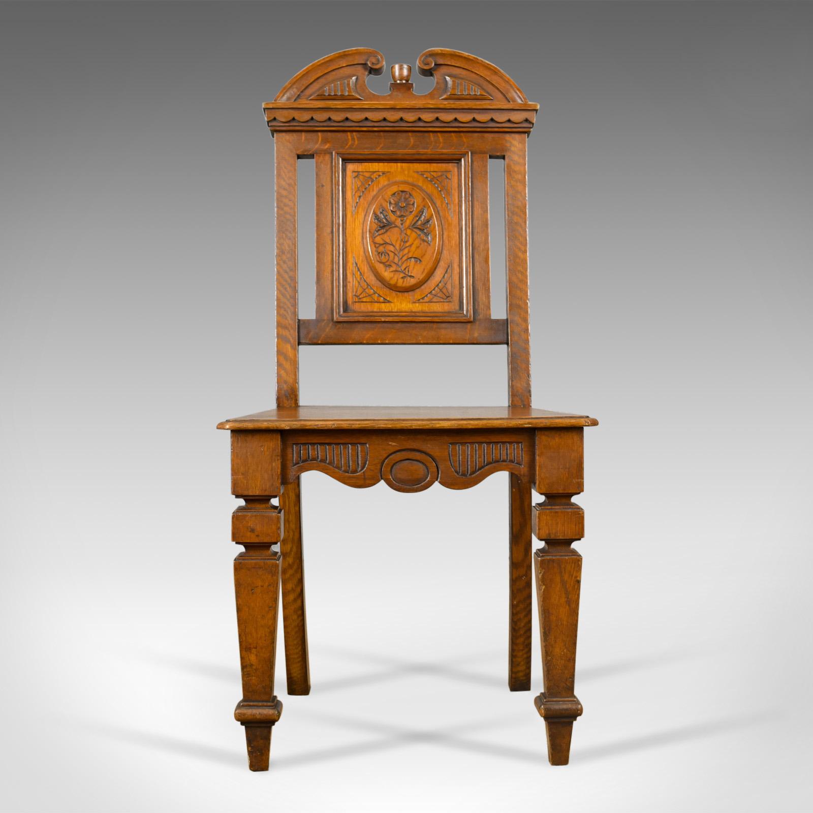 This is an antique hall chair in oak, a Scottish, Victorian side chair dating to the late 19th century, circa 1870. 

Attractive honey hues to the well figured oak
Solidly jointed with a wax polished finish
Of quality craftsmanship with a