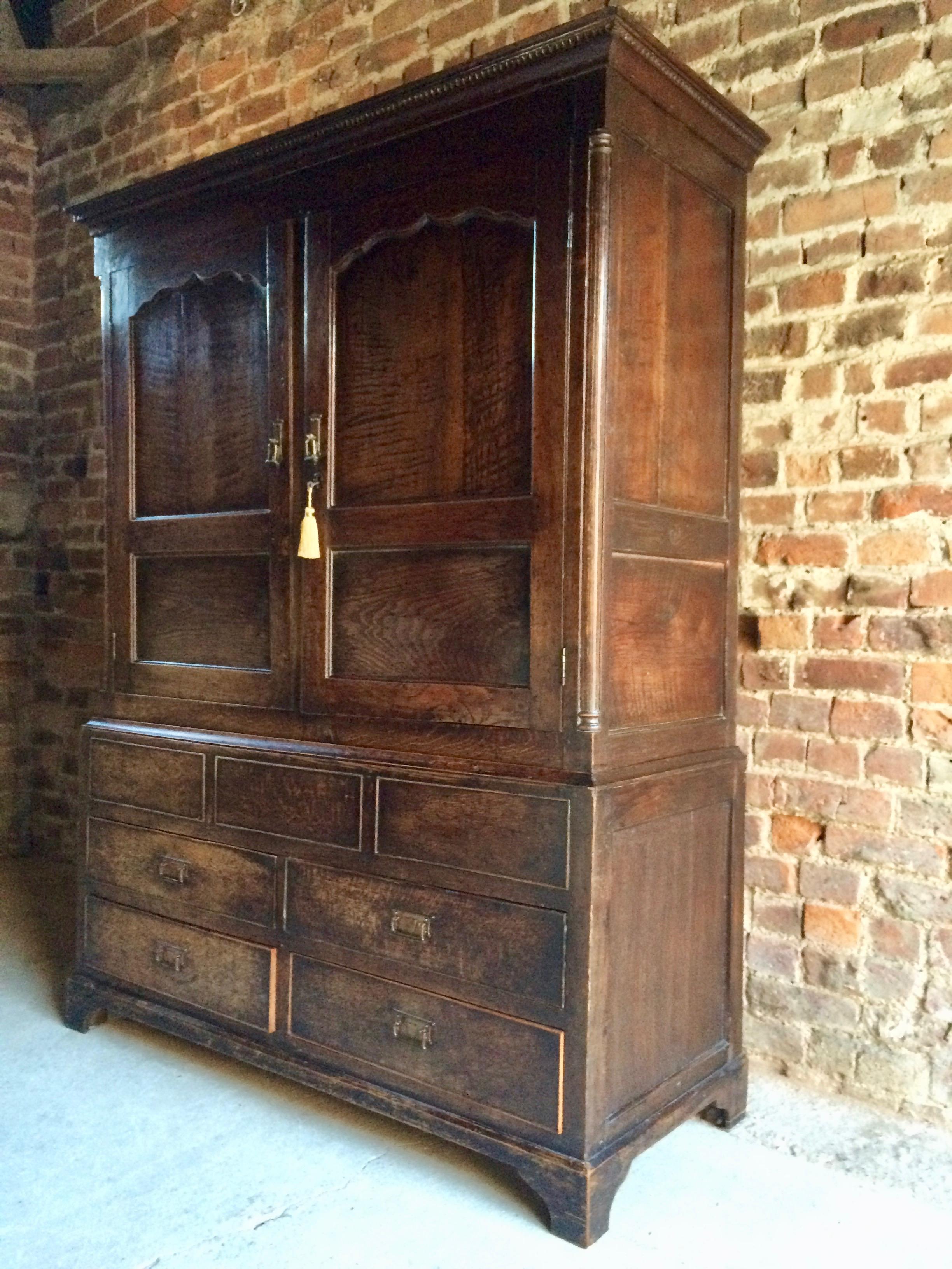 Antique hall cupboard solid oak Victorian, 19th century, circa 1890

A very handsome 19th century antique solid oak hall cupboard, circa 1890, the corniced top over two panelled doors with a number of hanging hooks within, above four short drawers