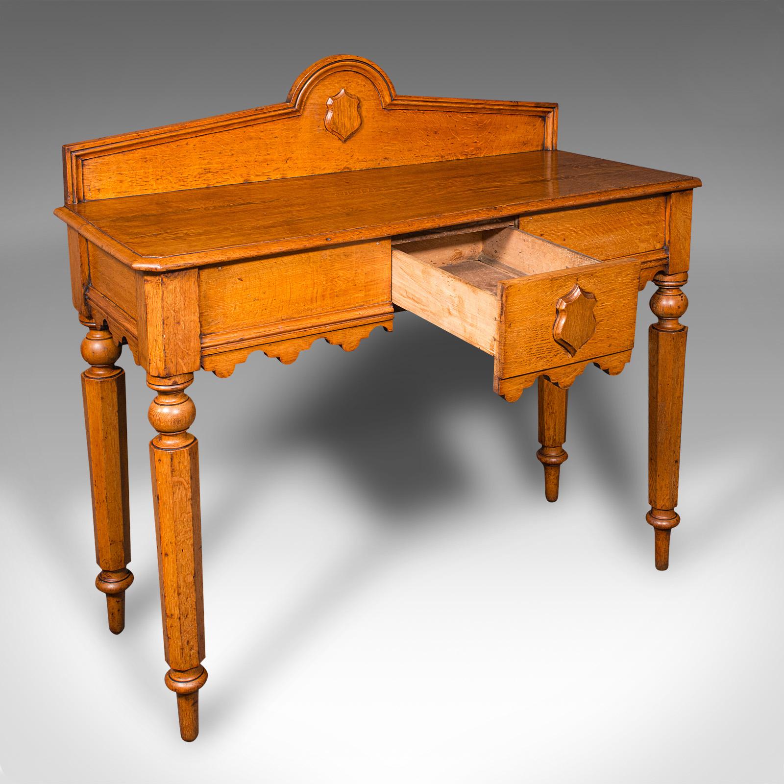 This is a distinguished early Victorian hall table, showcasing Scottish craftsmanship and Gothic Revival influences, circa 1850. This antique, golden oak console table boasts superb figuring, with an abundance of medullary rays enhancing its refined