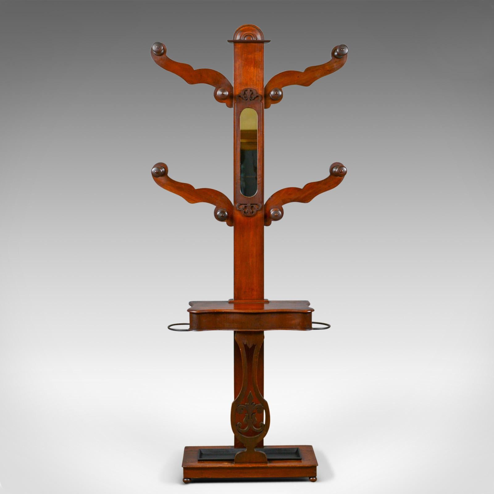 This is an antique hall stand. An English, Edwardian, mahogany 'tree', hat, coat, umbrella and glove valet stand dating to the early 20th century, circa 1910.

Of classic tree form and in good condition throughout
Deep russet tones to the