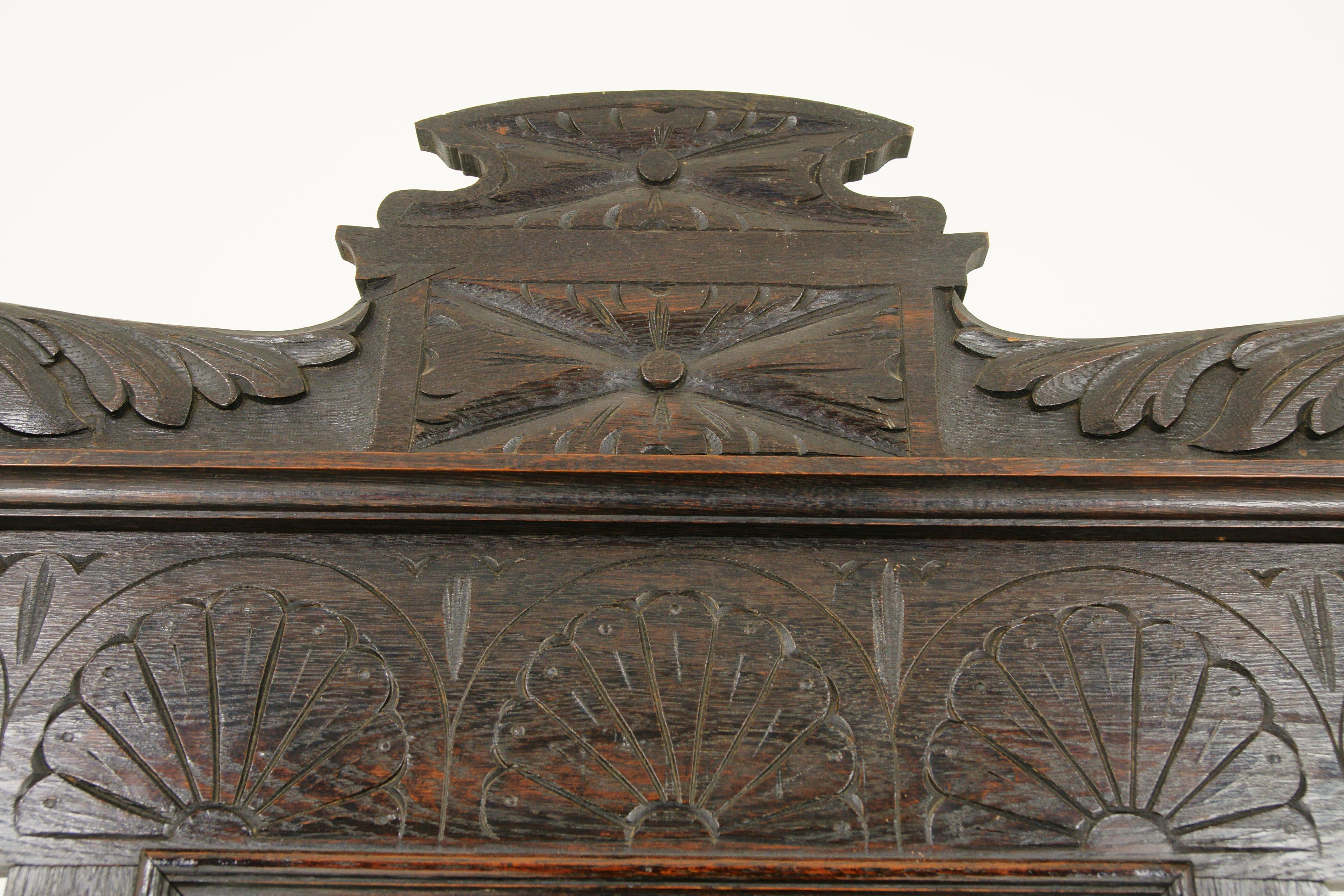 Antique hall stand, hat rack, coat rack, green man motif, Victorian, Scotland 1880, H054

Scotland, 1880
solid oak construction with original finish
carved pediment to the top
carved panel below
original rectangular mirror with some crazing
9 wooden
