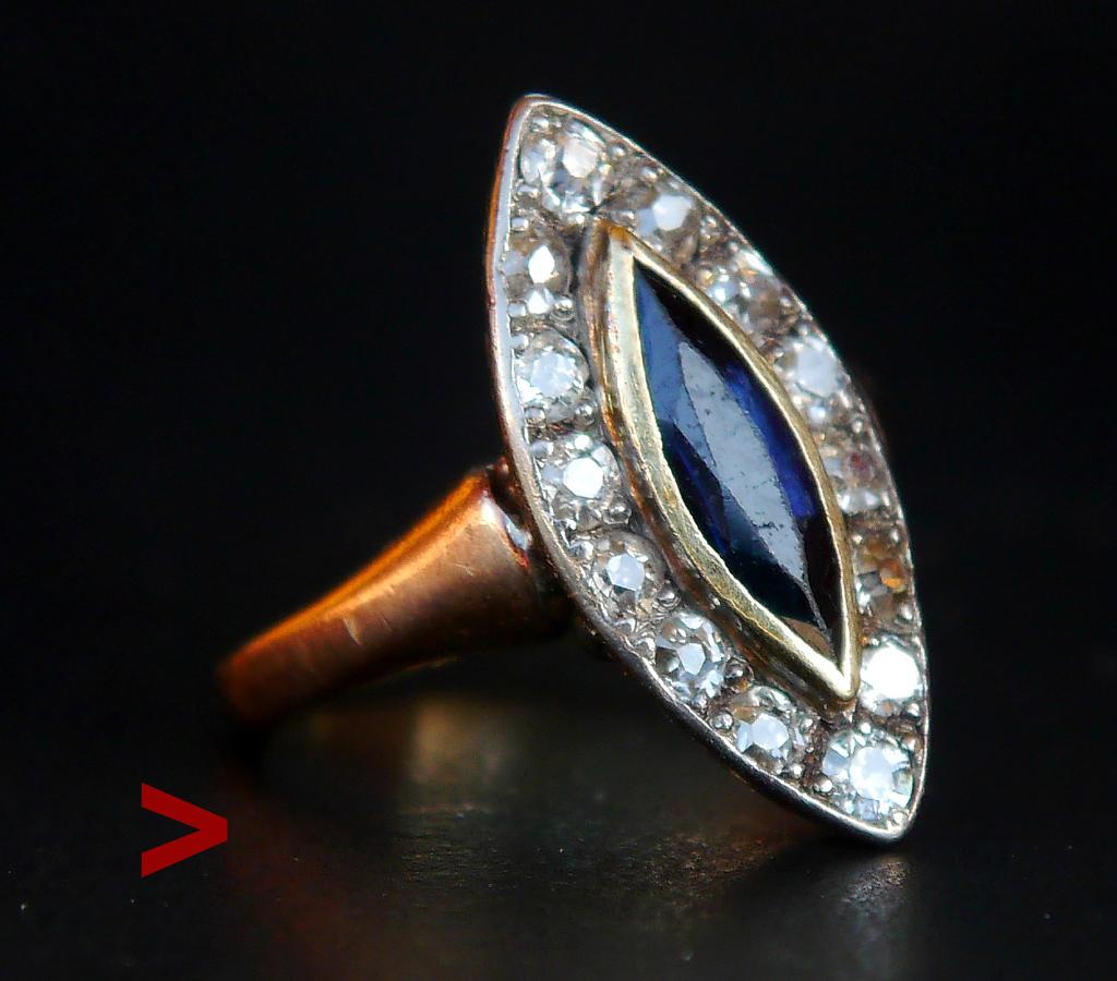 Dieser Ring hat Navette oder Boot-förmige Krone mit Marquise geschnitten natürlichen Saphir mit 14 alten Diamanten in Weißgold oder Platin Cluster auf Schultern und Band in massivem 14K Rose Gold montiert umgeben.
Es gibt auch eine Komponente, die