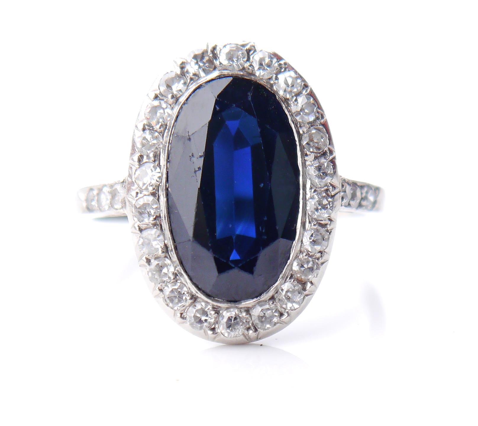 
Beautiful Platinum, Blue Sapphire + Diamonds Halo Flower Ring from 1920 -1930s. Likely German,all metal parts of this ring are made of solid Platinum. 
Crown measures 17 mm x 12 mm x 5 mm. 
Oval cut natural Blue Sapphire stone of darker tone is