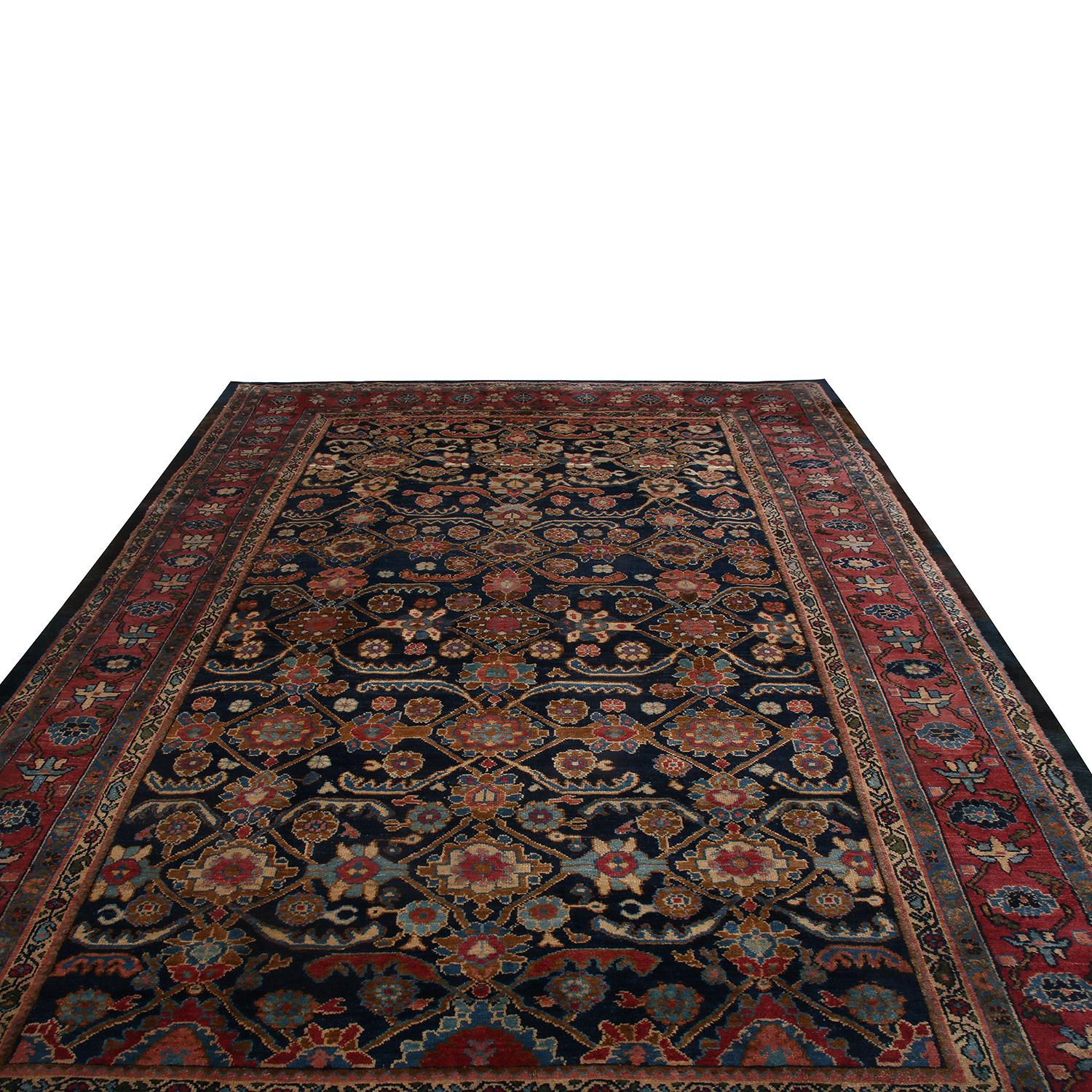 Hand knotted in Persia originating between 1880-1890, this antique geometric-floral rug hails from the city of Hamadan, enjoying distinct geometric-floral patterns with an equally individualistic, complementary colorway. The navy blue background