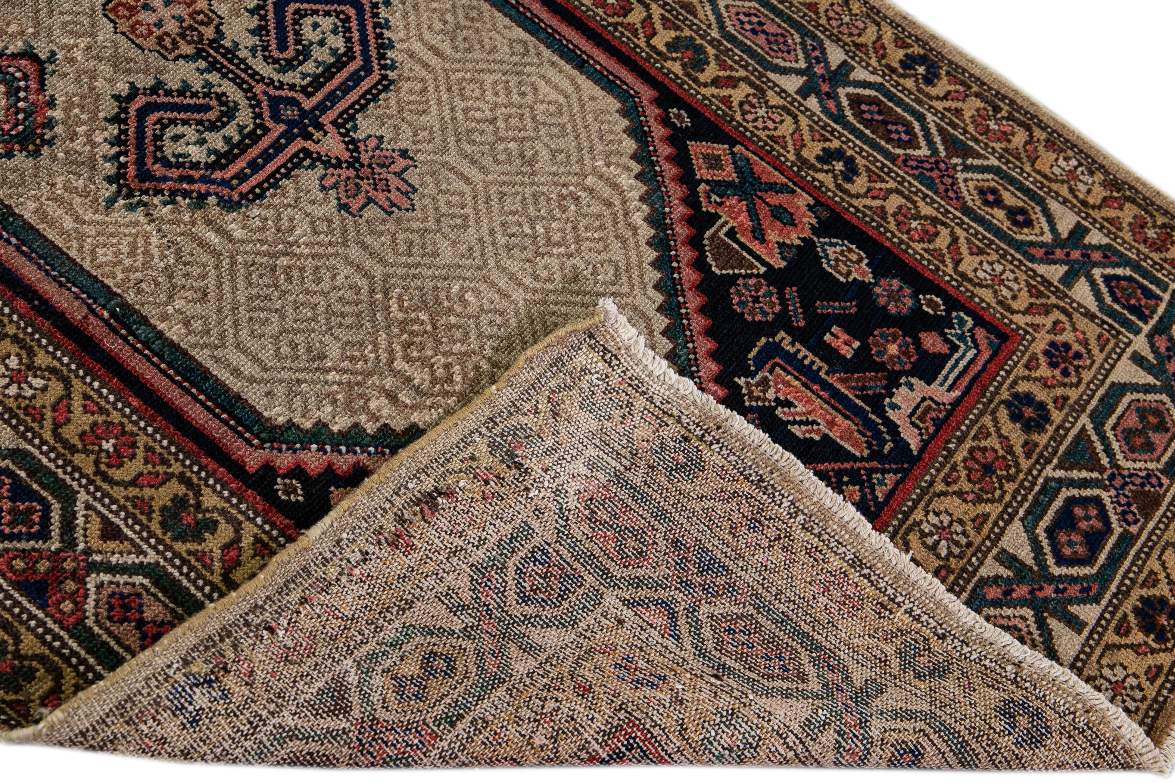 Beautiful antique Hamadan hand-knotted wool runner with a brown and beige field. This Persian runner has a geometric medallion design in complementary colors. 

This rug measures: 3'1