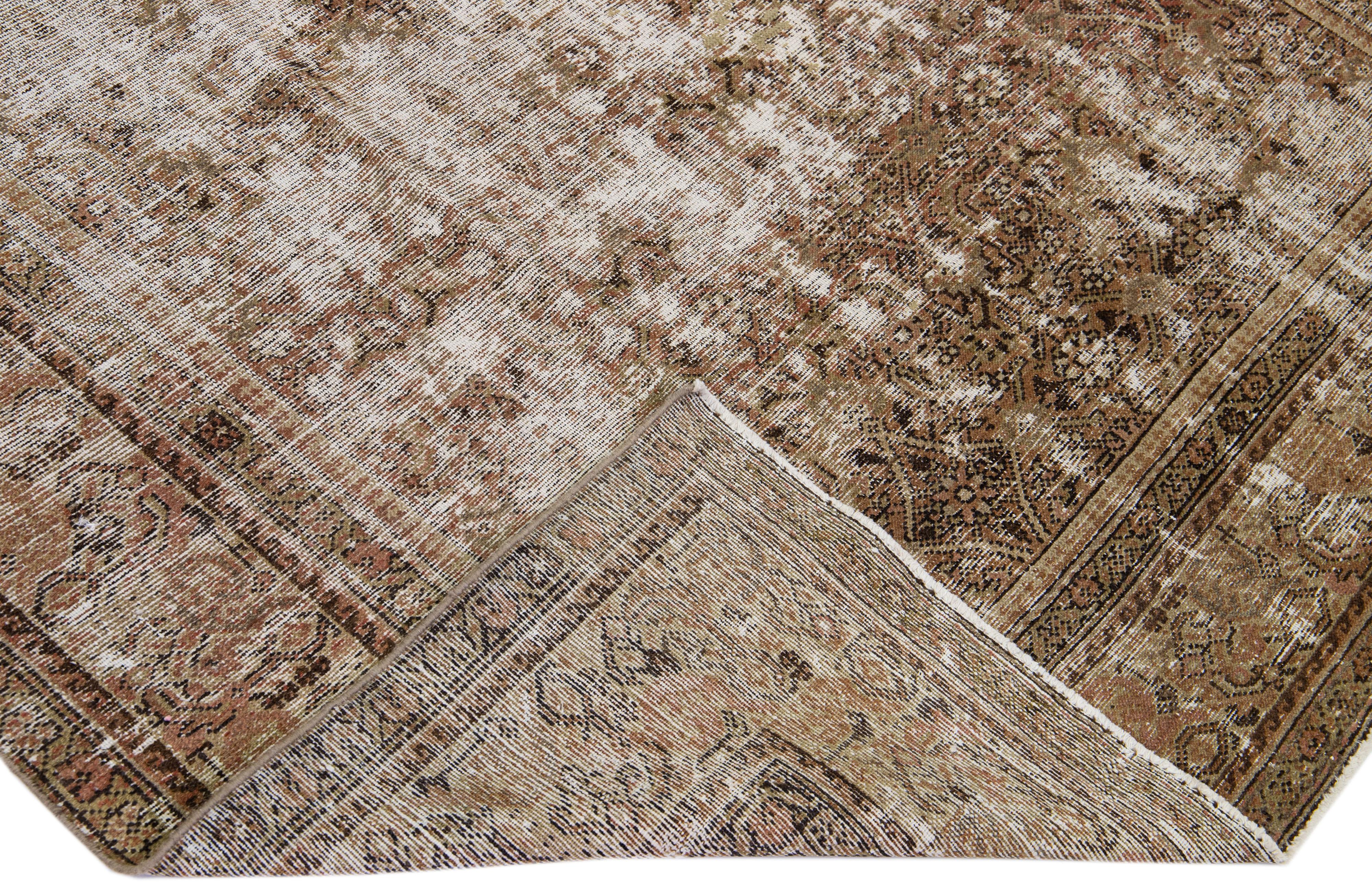 Beautiful antique Hamadan hand-knotted wool rug with a beige field. This Persian piece has brown and blue accents in a gorgeous all-over floral pattern design.

This rug measures: 6' x 16'5