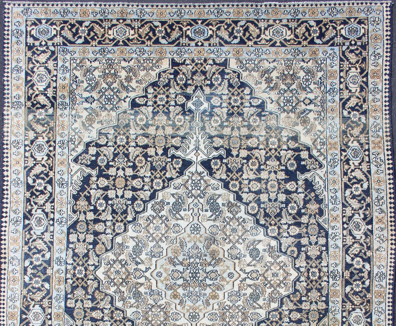Persian antique carpet with center medallion and flower motifs, rug R20-0504, country of origin / type: Iran / Hamadan, circa 1920.

This antique Hamadan carpet from 1920s Persia features a traditional medallion design rendered in a variety of