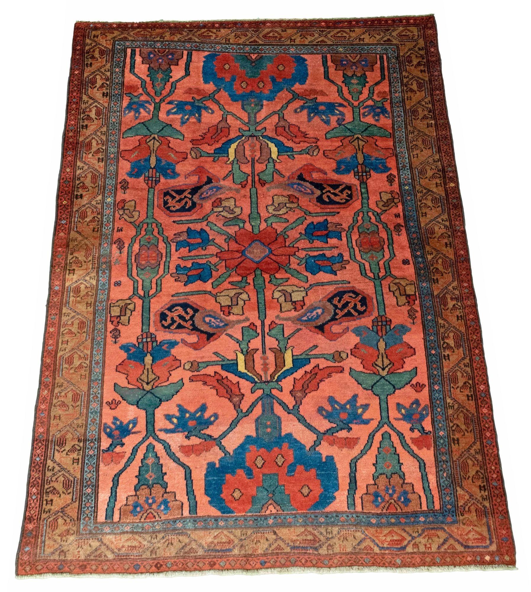 A beautiful antique Hamadan rug, hand woven circa 1920 with an unusual floral design on a pinky red field and camel border. Wonderful secondary colours including a lovely teal in the field and a highly decorative rug. Note the small animal figures