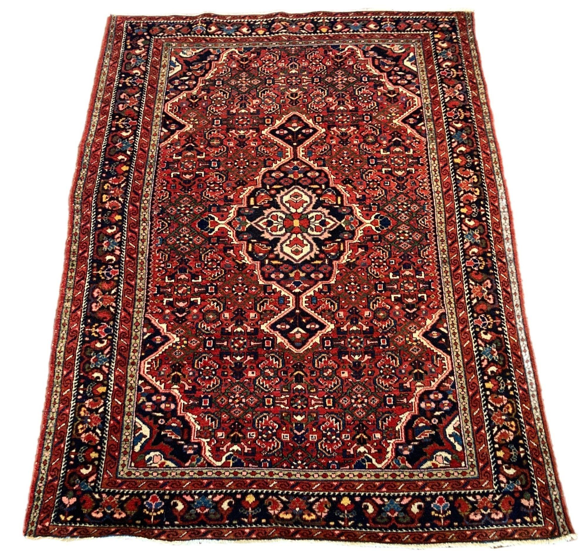 A lovely antique Hamadan rug, handwoven circa 1920 featuring a Mahi design on a terracotta field around an elegant deep indigo medallion and similar border. Fabulous secondary colours, especially the light green and gold in the main design.
Size: